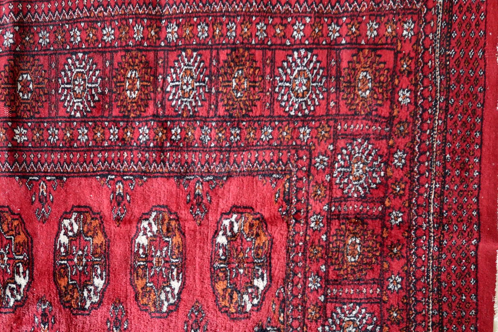 This handmade vintage Turkmen Ersari rug from the 1960s is a beautiful example of traditional craftsmanship. Measuring 4.2 feet (129 cm) in width and 6.4 feet (196 cm) in length, this exquisite wool rug is in good condition, adding a touch of