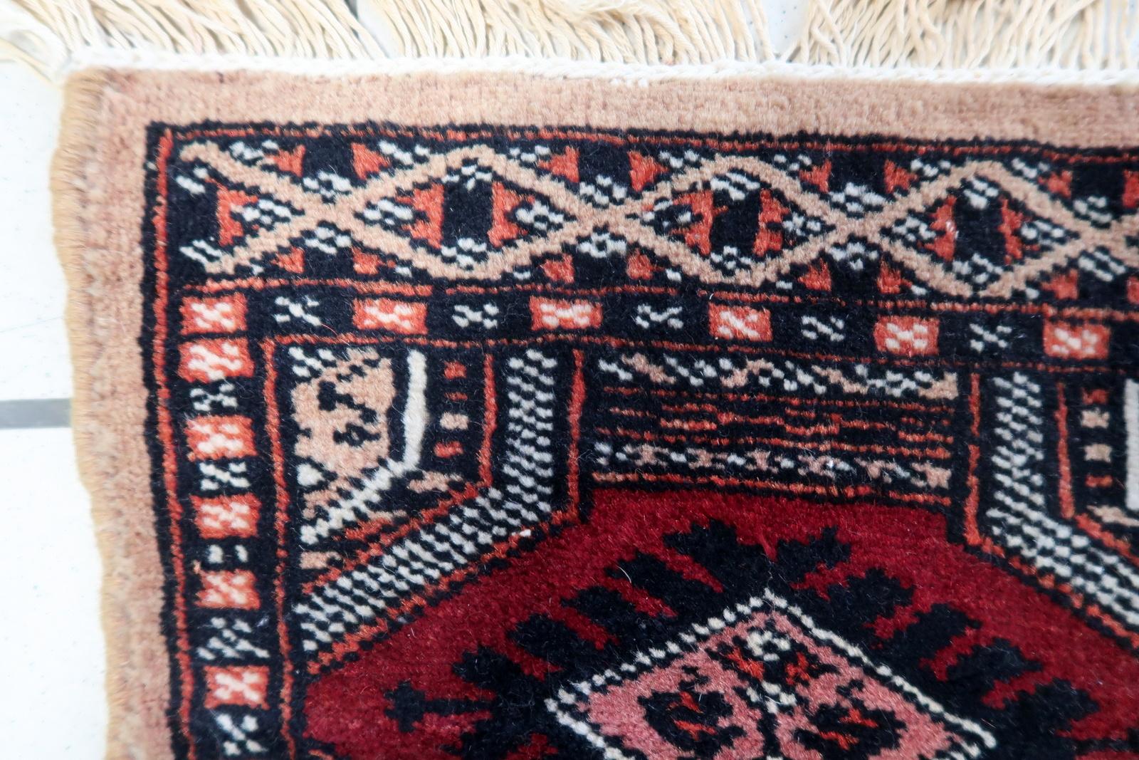 Handmade Vintage Uzbek Bukhara Mat Rug:

Design and Colors:
This square-shaped rug showcases intricate craftsmanship.
The dominant colors include:
Deep Reds: These warm tones evoke a sense of tradition and spirituality.
Blacks: Adding contrast and