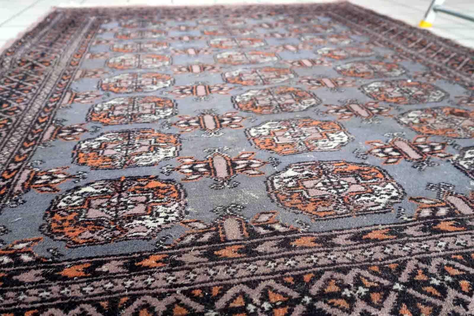 Handmade vintage Uzbek Bukhara rug in traditional design. The rug is from the end of 20th century made in wool. The rug is in original condition, has some low pile.

-condition: original, some low pile,

-circa: 1960s,

-size: 4.1' x 6.2' (127cm x