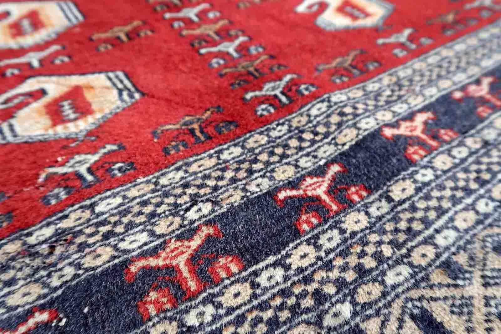 Handmade vintage Uzbek Bukhara rug in red color. The rug has been made in wool in the middle of 20th century. It is in original condition, it has some low pile.

-condition: original, some low pile,

-circa: 1960s,

-size: 4.1' x 6.4 (126cm x