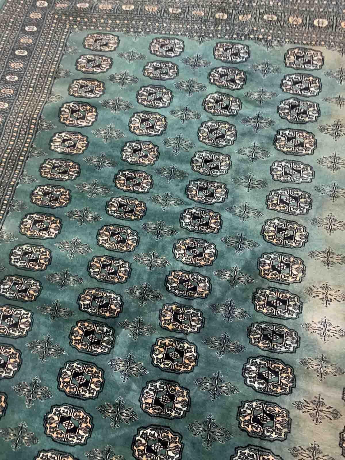 Handmade vintage Uzbek Bukhara rug in Turquoise shade and traditional design. The rug is from the end of 20th century in original condition, it has some age discolorations.

-condition: original, age discolorations,

-circa: 1970s,

-size:
