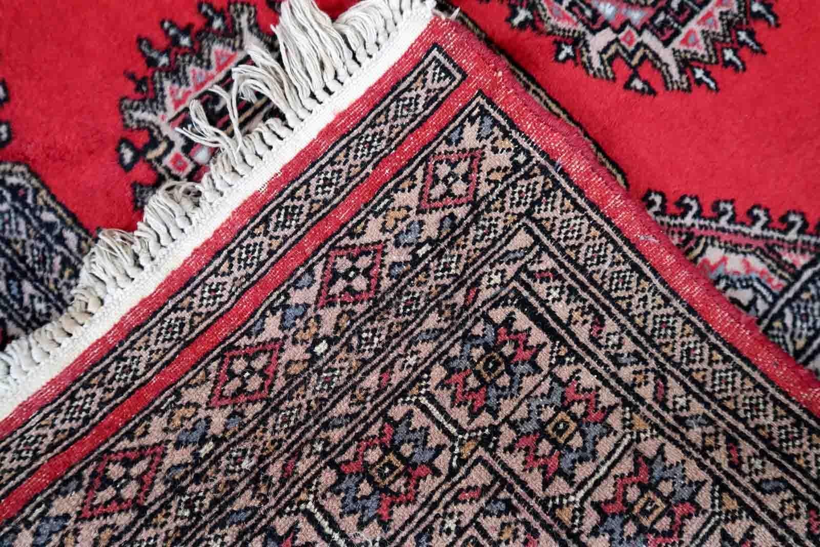 Handmade vintage Uzbek Bukhara rug in red color. The rug has been made in wool in the end of 20th century. It is in original condition, it has some signs of age.

-condition: original, some signs of age,

-circa: 1970s,

-size: 3' x 6.1' (92cm