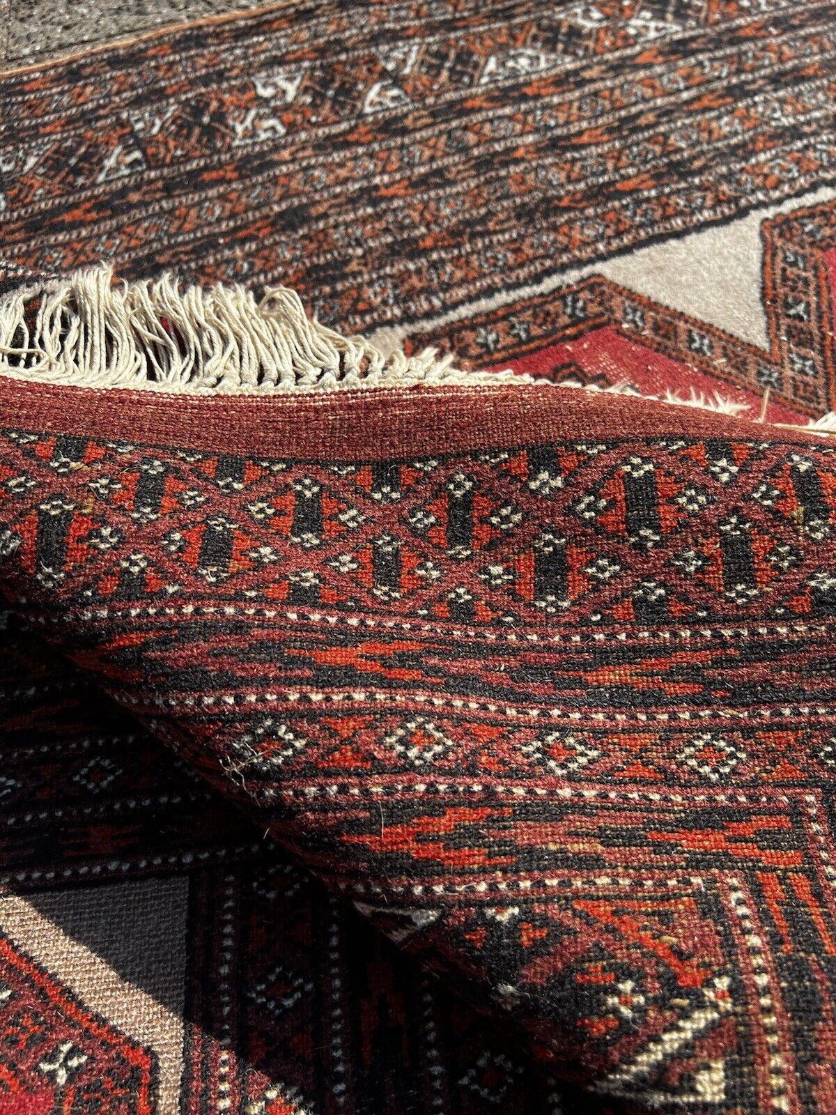 Presenting our Handmade Vintage Uzbek Bukhara Rug, a remarkable piece from the 1960s that embodies the rich tapestry of Central Asian artistry. This rug is a testament to the skill and dedication of the weavers who have preserved the traditional