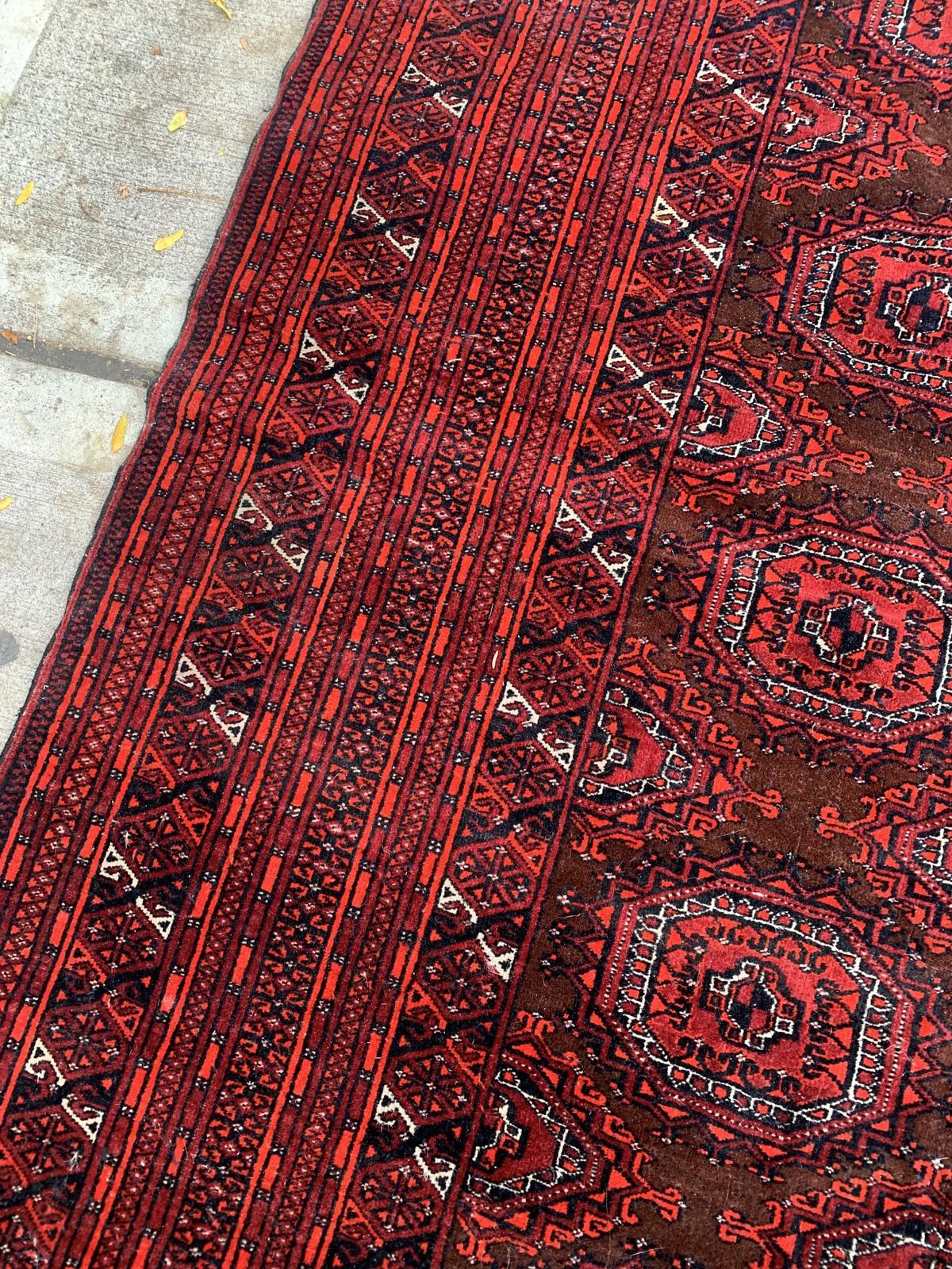 Introducing our remarkable Handmade Vintage Uzbek Bukhara Rug, a stunning piece that hails from the 1960s and encapsulates the enduring allure of traditional Uzbek craftsmanship. In its original good condition, this rug exudes authenticity and