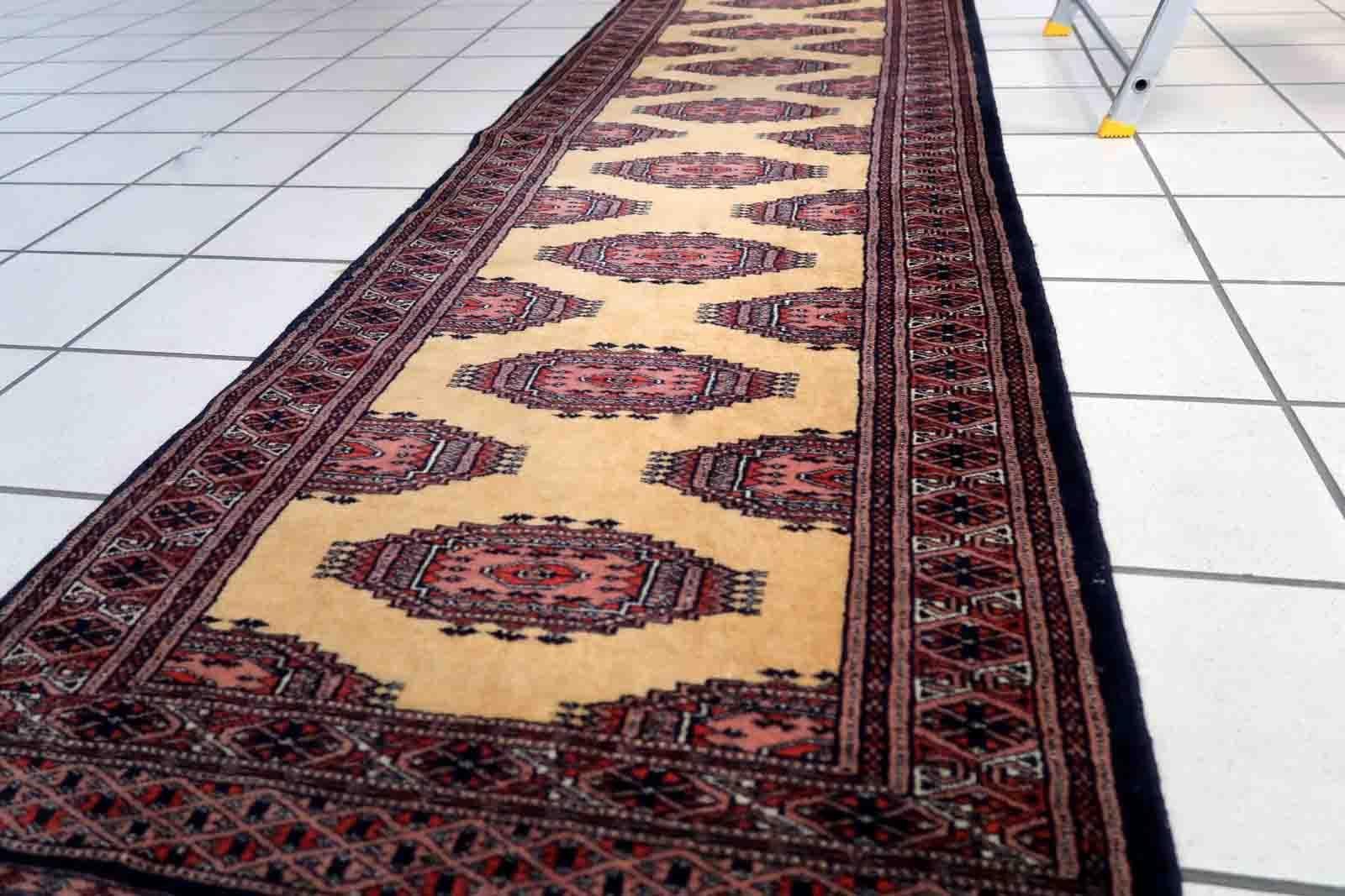 Handmade vintage Uzbek Bukhara narrow runner in yellow wool. The rug has traditional design. It is from the end of 20th century, in original good condition.

-condition: original good,

-circa: 1970s,

-size: 2.1' x 6.8' (65cm x
