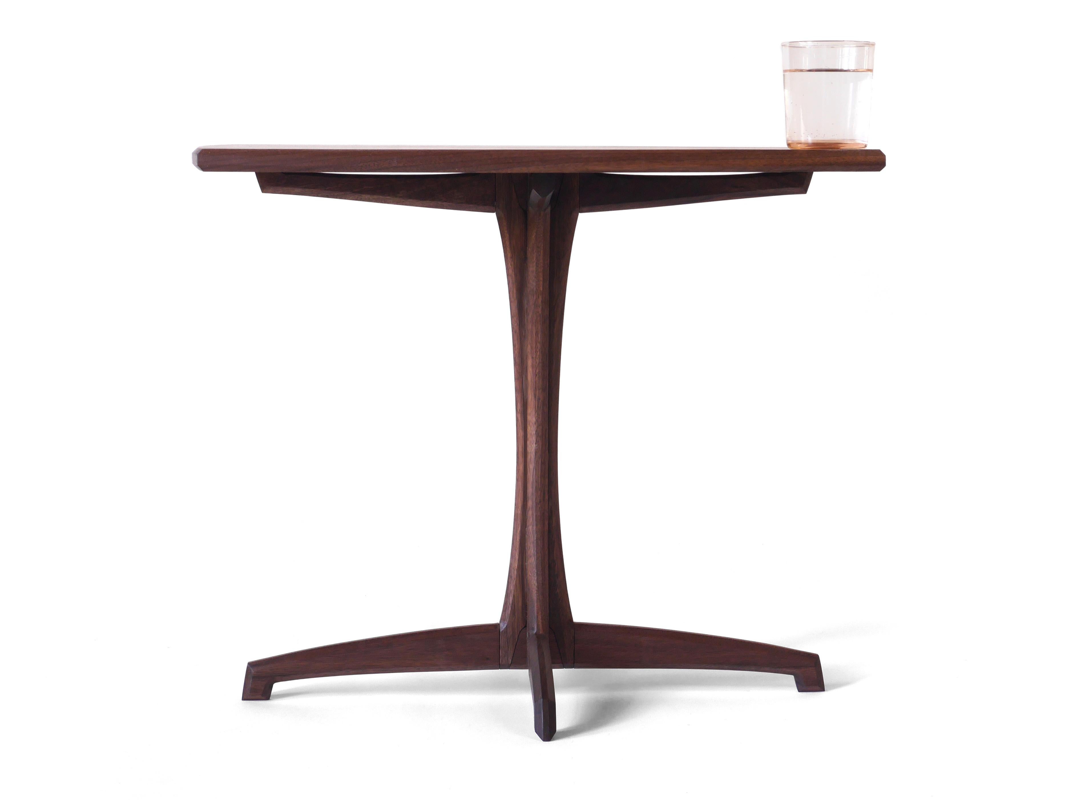 This elegant Plume Side Table is made out of solid black walnut hardwood and has a detail rich grace highlighted by its simplicity. Each piece is built to order one at a time by master craftspeople in our shop in Albuquerque, NM, and assembled to