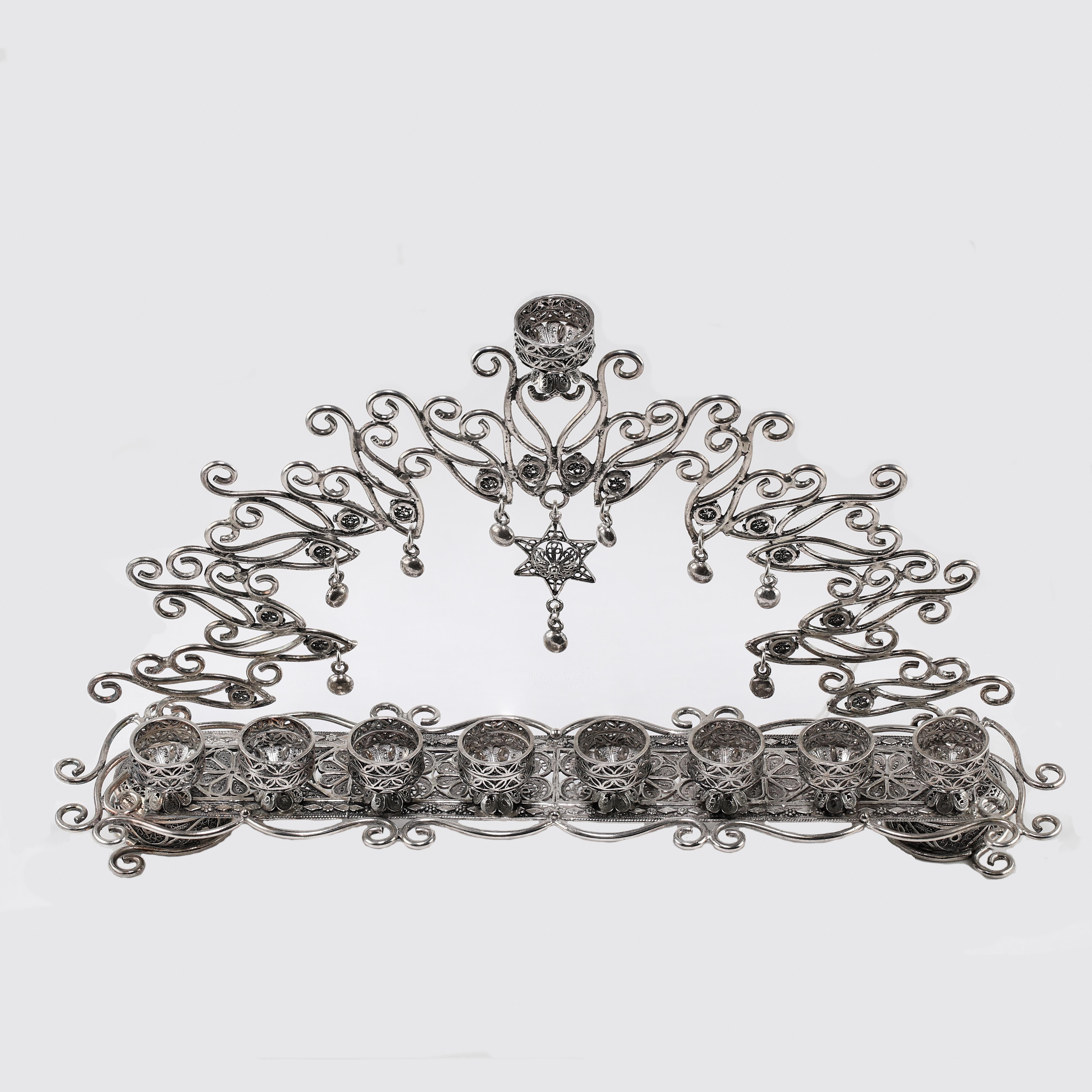 Whimsical Menorah for Hanukkah. A beautiful piece that is all handcrafted with Solid Sterling Silver in Israel with fine yemenite workmanship that was created 100’s of years ago. The Yemenite filigree technique is all hand done, and still practiced