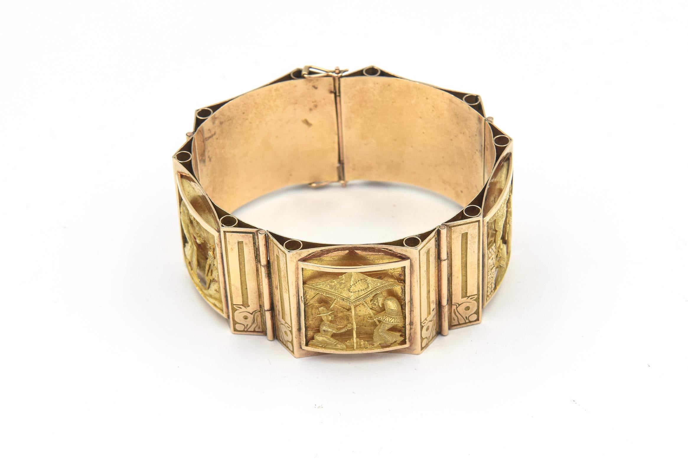 This highly detailed 18k yellow and rose gold bracelet features 5 ornate 3 dimensional plaques.  The workmanship on each scene is beautiful.  The bracelet tells a story through each scene.  On has a man sailing with the wind at his back,  The next