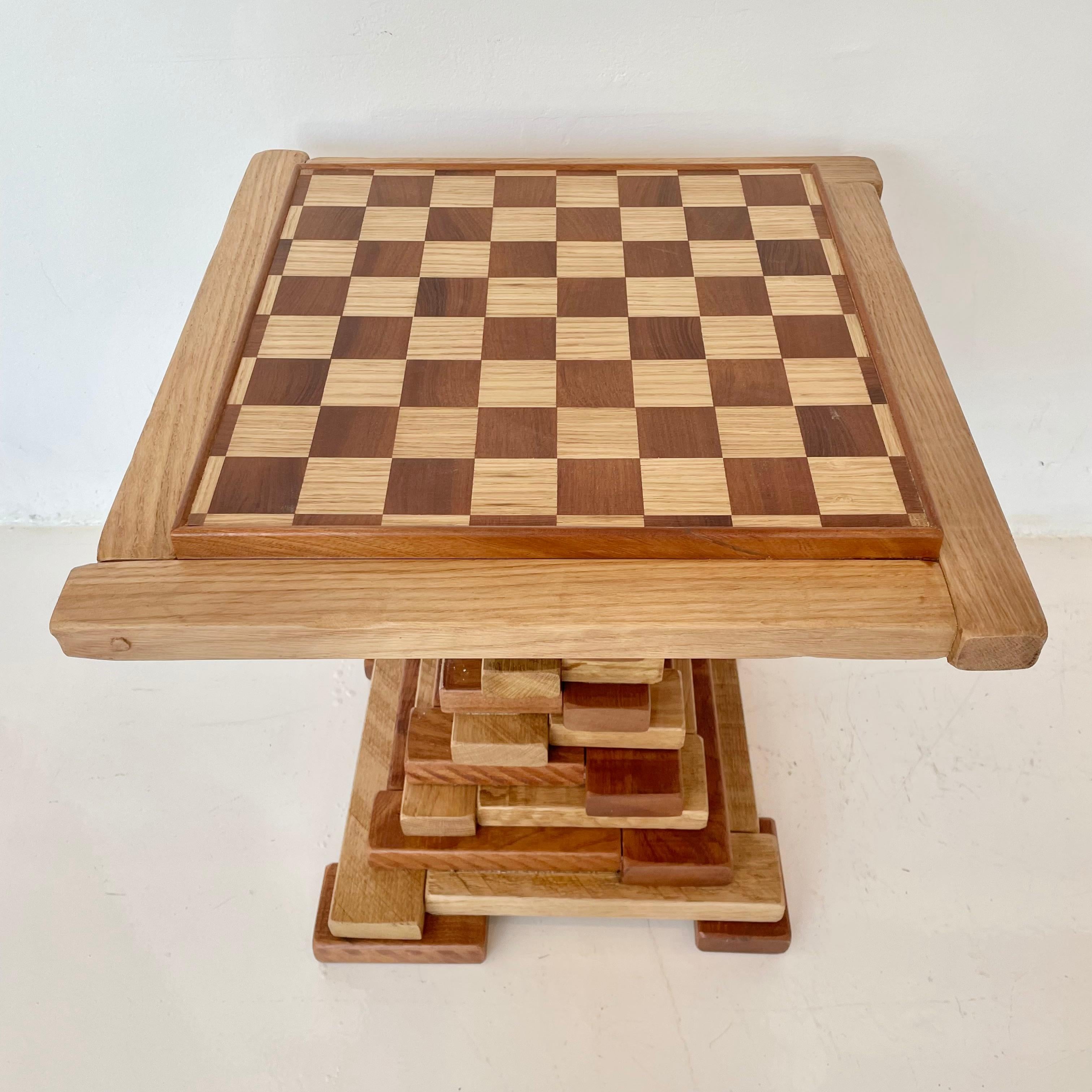 Stunning sculptural handmade chess table made from wood blocks. Gorgeous coloring and design. Tan and brown alternating wood blocks give this piece great texture while it's hourglass shape gives it nice depth. Perfect game table. Table top can be