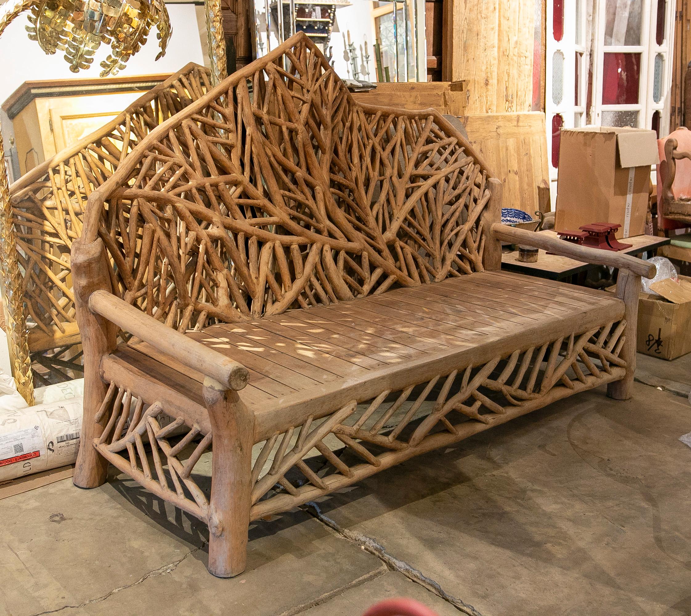 Handmade wooden sofa made of wooden logs for the garden.