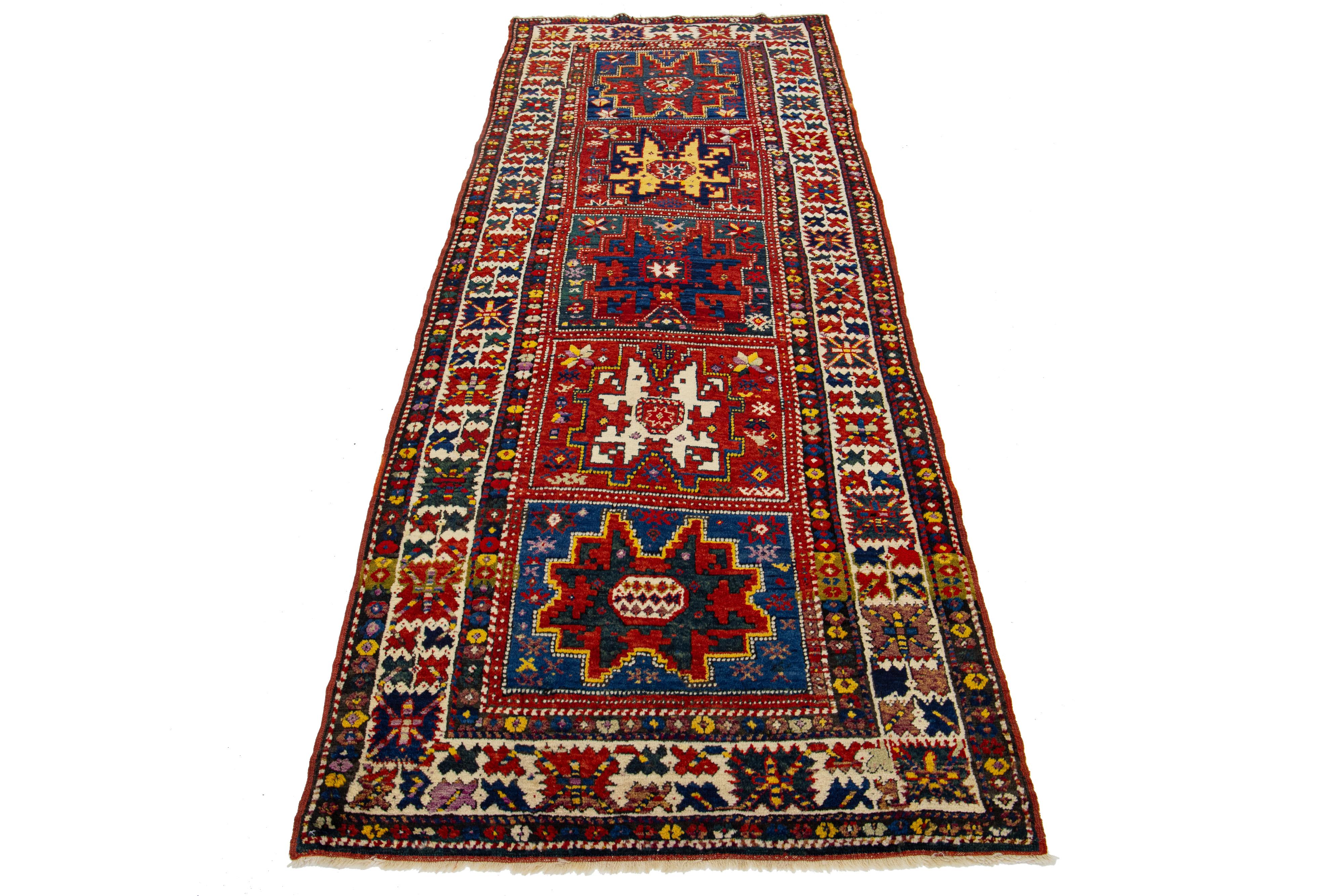 Beautiful 1900s Kazak hand-knotted wool rug with a red color field. This piece has multicolor accents in an all-over Tribal motif.

This rug measures 3'7