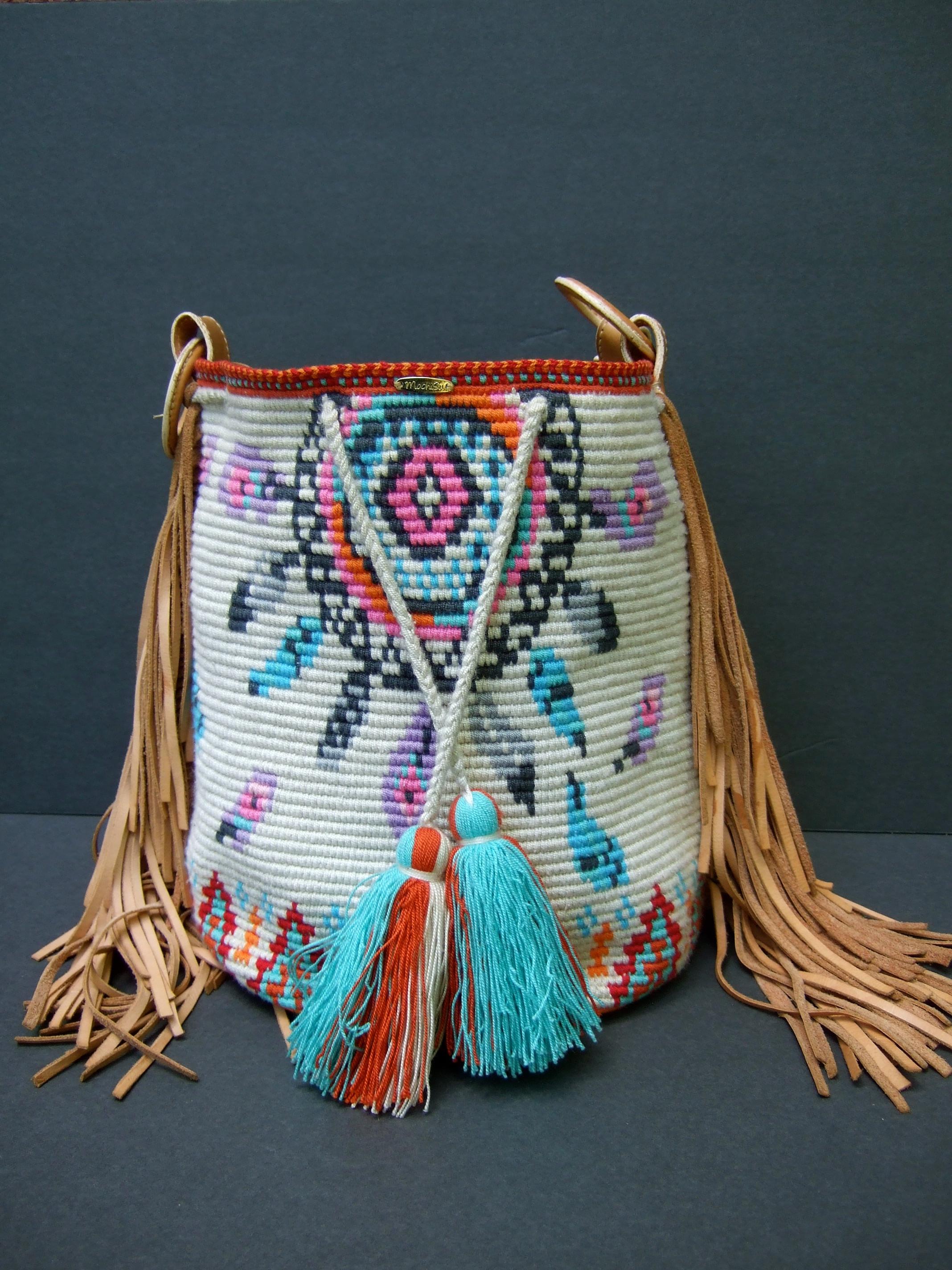 Handmade woven wool knit artisan bucket style shoulder bag c 1990s
The unique wool knit bucket style shoulder bag is designed 
with pastel south western style knit designs replicated on both
exterior sides

The bucket style knit shoulder bag is