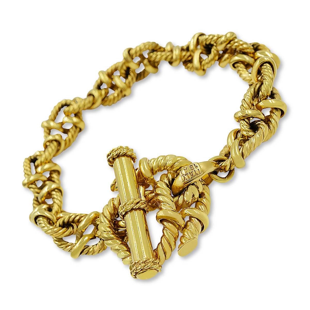 Gold knotted rope bracelet circa 1980. Designed as a bright 18-karat yellow gold rope tied in a series of open knots, this is a chunky-gold-bracelet-lover's dream come true. Definitely makes a statement with its colossal size and unique design. It