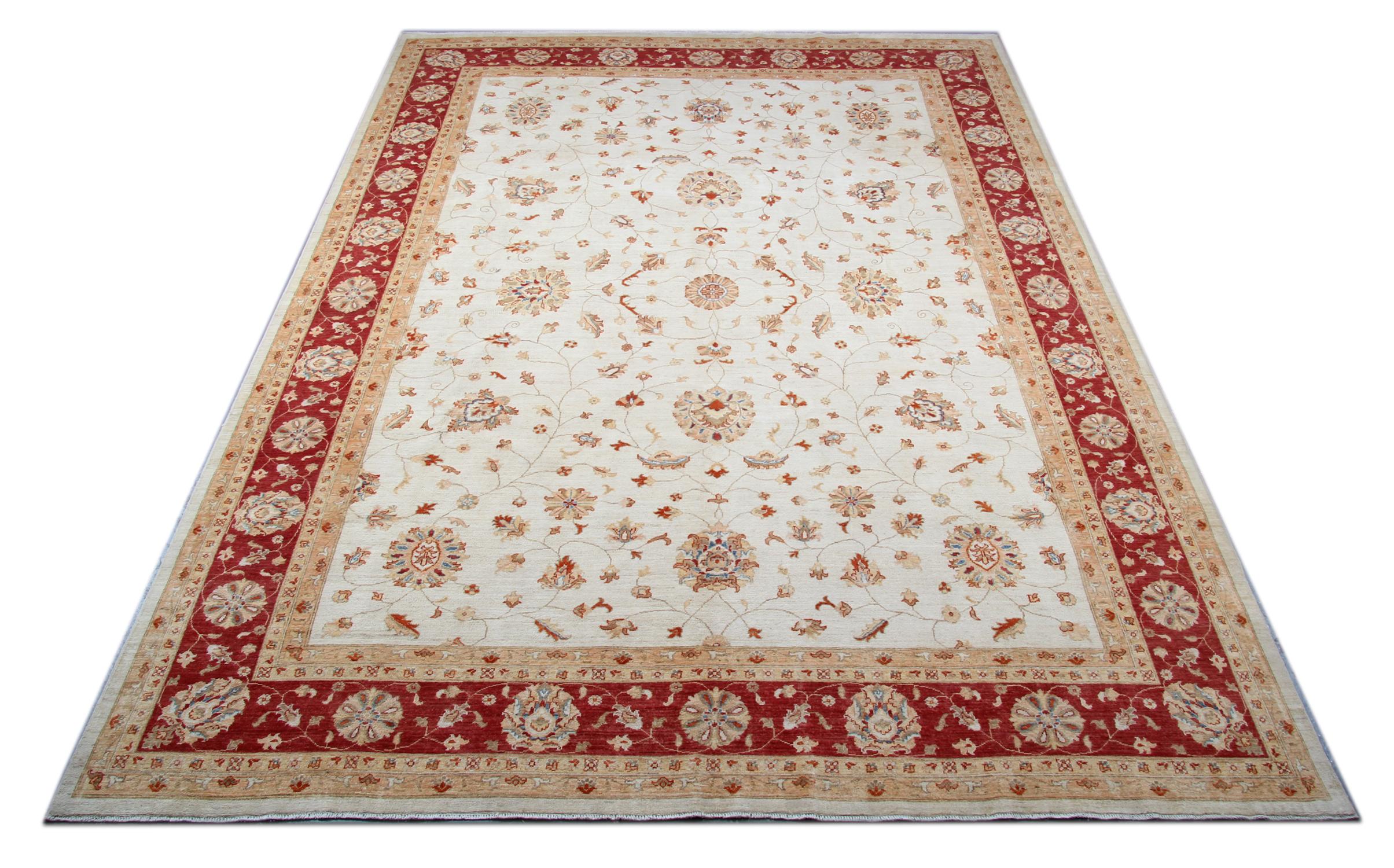 This rug is a Ziegler Sultanabad rug was constructed on our looms by our master weavers in Afghanistan. Featuring a cream and beige floral design woven on an ivory background and a bold red border. Handmade with all natural veg dyes all hand spun