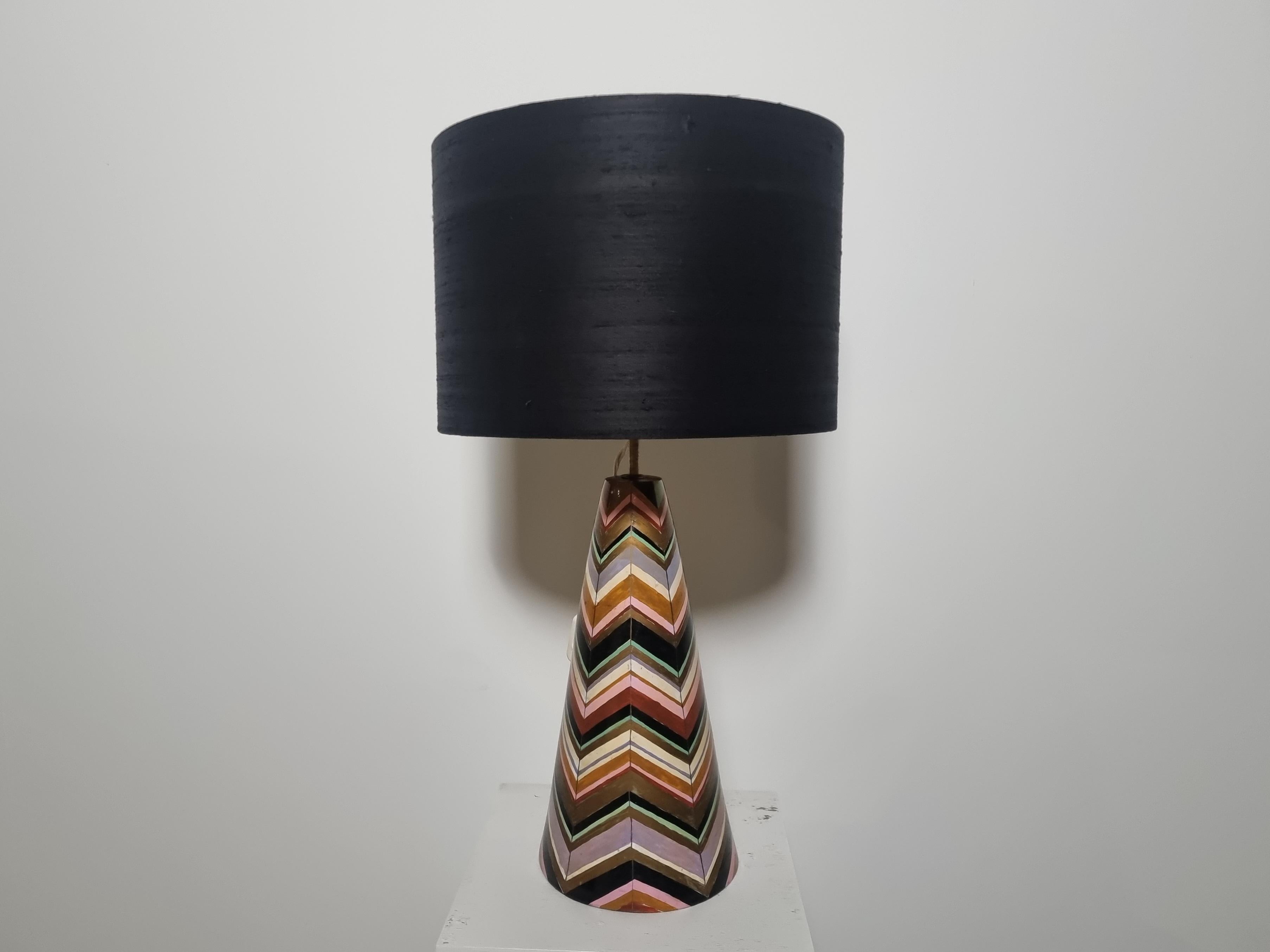 Ceramic lamp in multi-colored handpainted lacquer decoration, the lampshade in black and gold interior is handmade from interior fabric, Italy, 1970s.