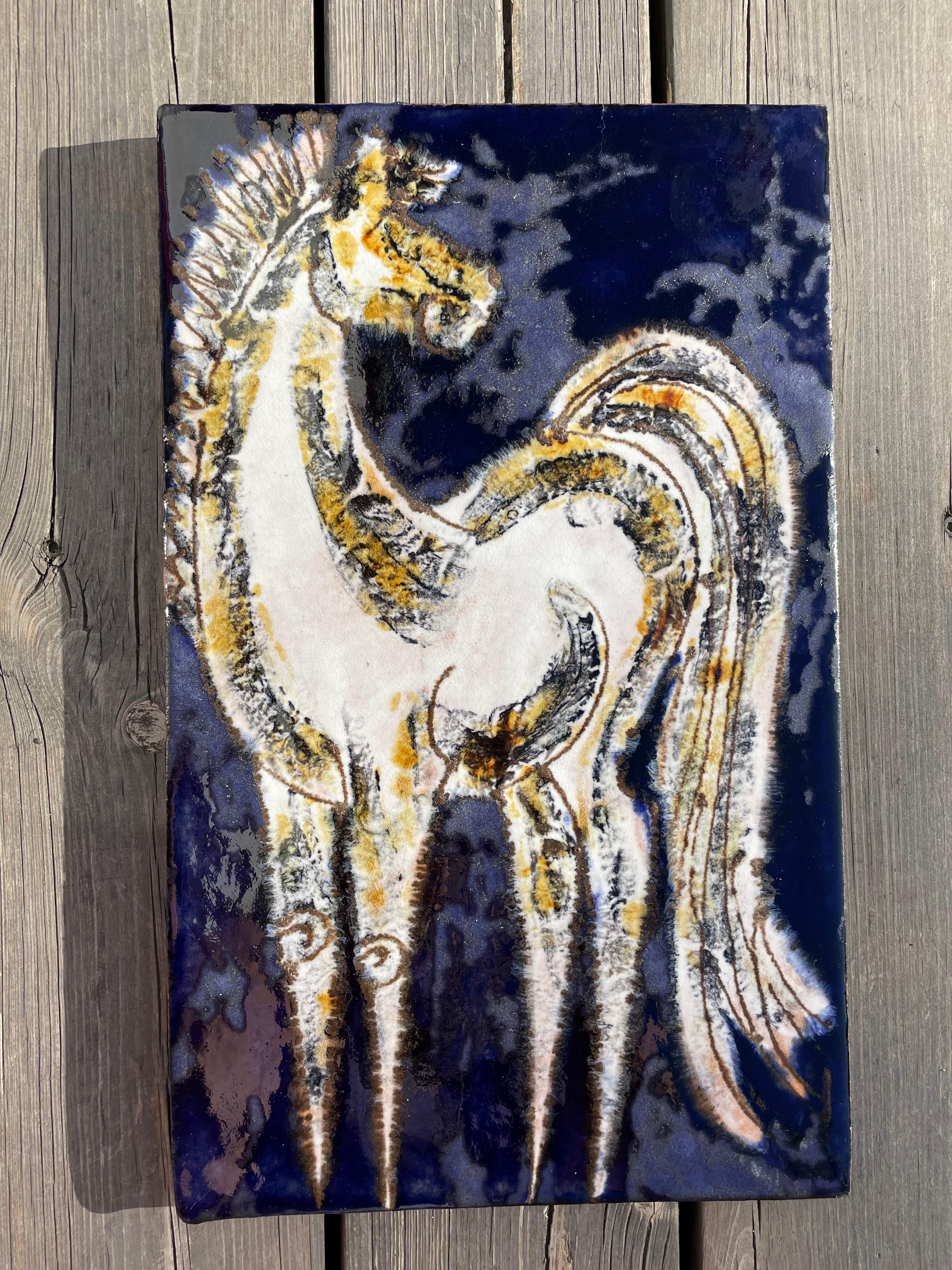 Handmade midcentury modern rectangular ceramic wall plaque with expressive white horse motif. Matte and shiny glaze in blue, white, yellow and light gray colors. Metal mount for wall hanging on back. Manufactured by Ruscha in the 1960s. Signed and