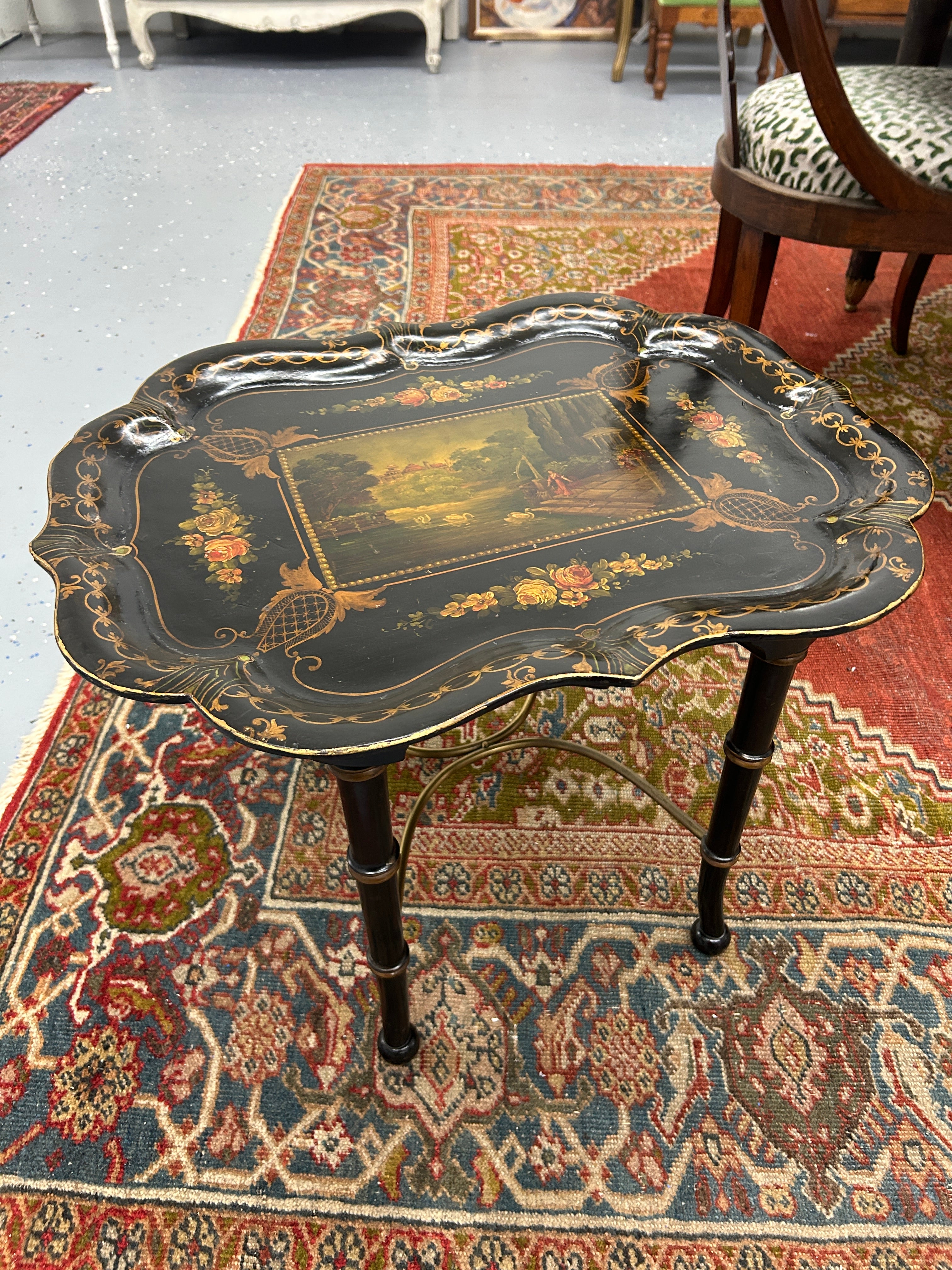 Introducing an exquisite small black lacquer tea table with a touch of timeless elegance. This charming piece, resting gracefully on faux bamboo legs, invites you to step into a world of sophistication and artistic beauty.

Crafted in the early 20th