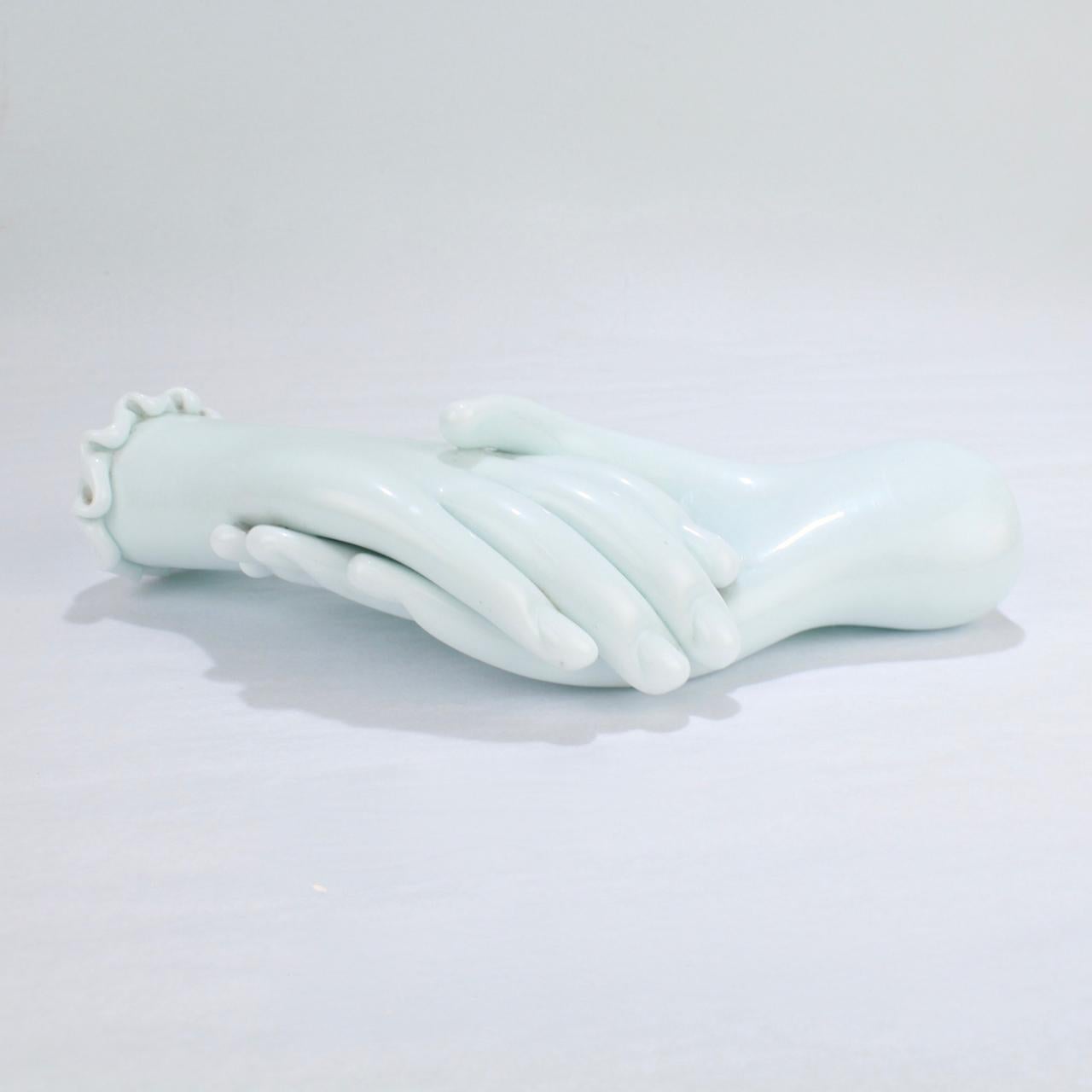 An exceptionally rare figurine by Fulvio Bianconi for Venini & Co.

Referred to as 'Handshake', the model consists of a gloved hand with a scalloped cuff shaking hands with a naked hand in lattimo glass.

This model was part of important series