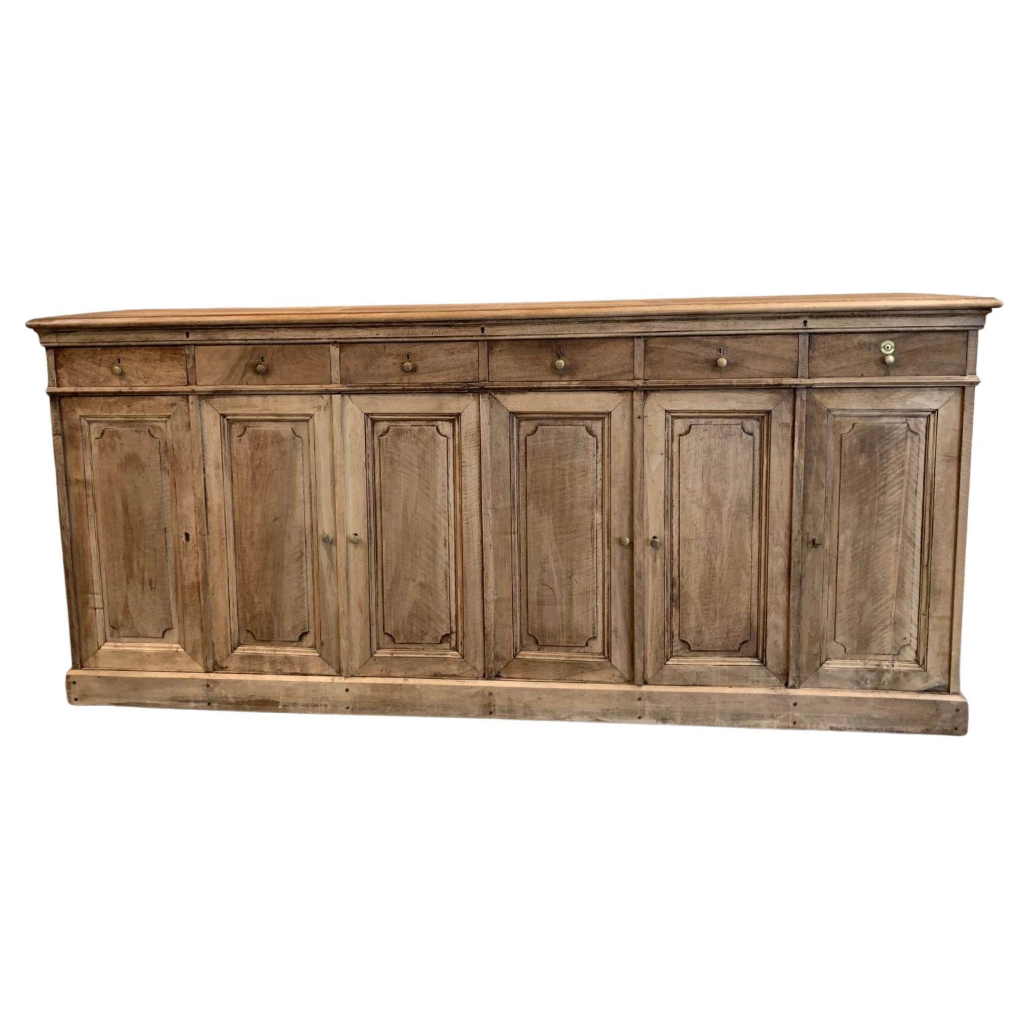 Handsome and quality carpentry-made antique side board/chest of drawers. Made in France circa 1940s in a solid and simple design, with drawers and plenty of storage space, as well as remarkable interior detailing.

Has a distinctly clerical work