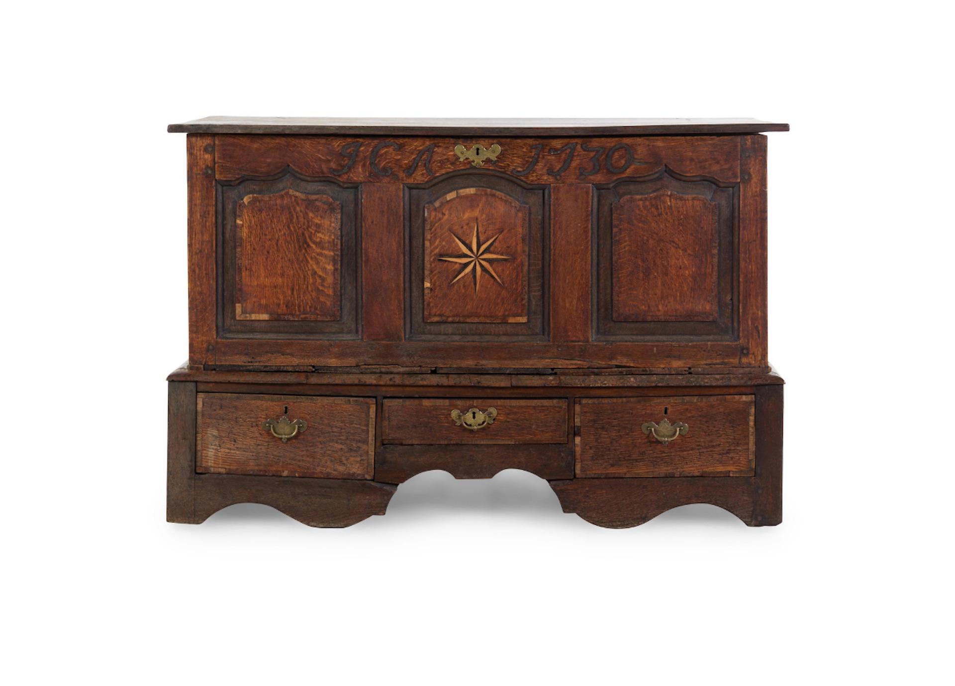 Handsome 18th century English oak chest with star inlay, dated 1730. Great patina and color, lift top over three drawers.