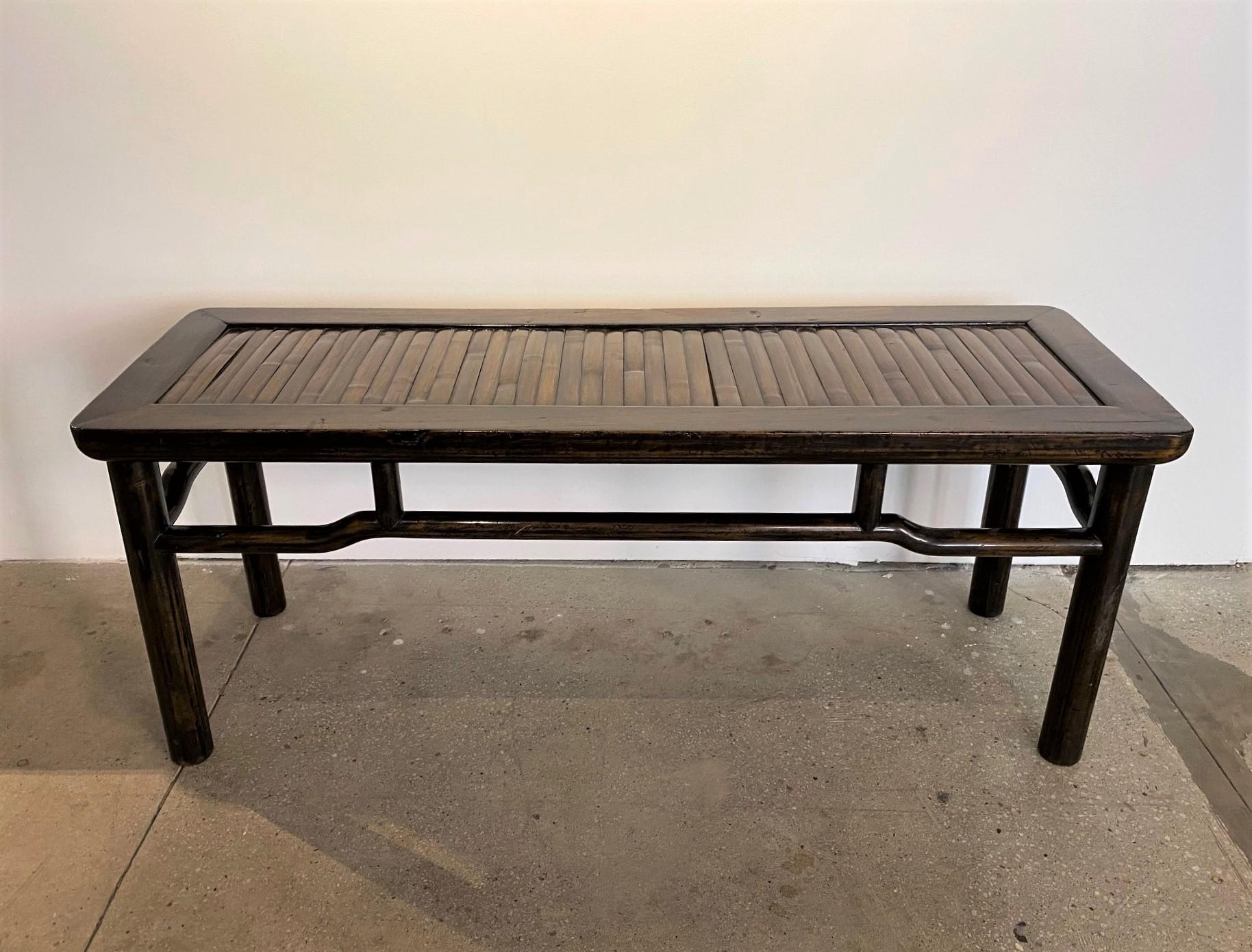 This piece can be used in many different locations. A bench at the end of the bed or your foyer/mudroom. Or its ideal for a narrow coffee table. Either way this handsome 19th Century Chinese Jumu Wood Bench with Bamboo Inset Seat will add character