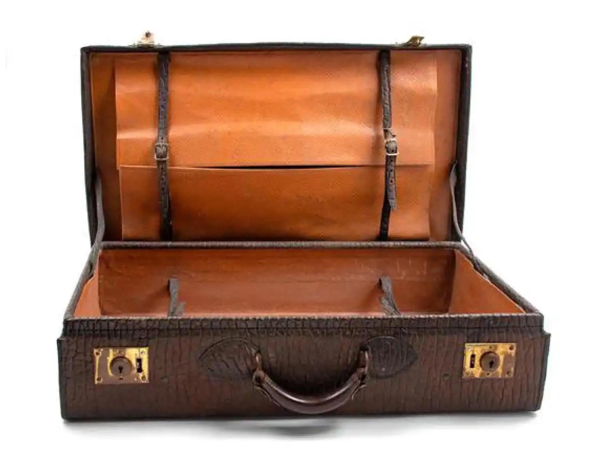 Handsome 19th century suitcase with embossed leather. Great as a collection used as a side table or coffee table.