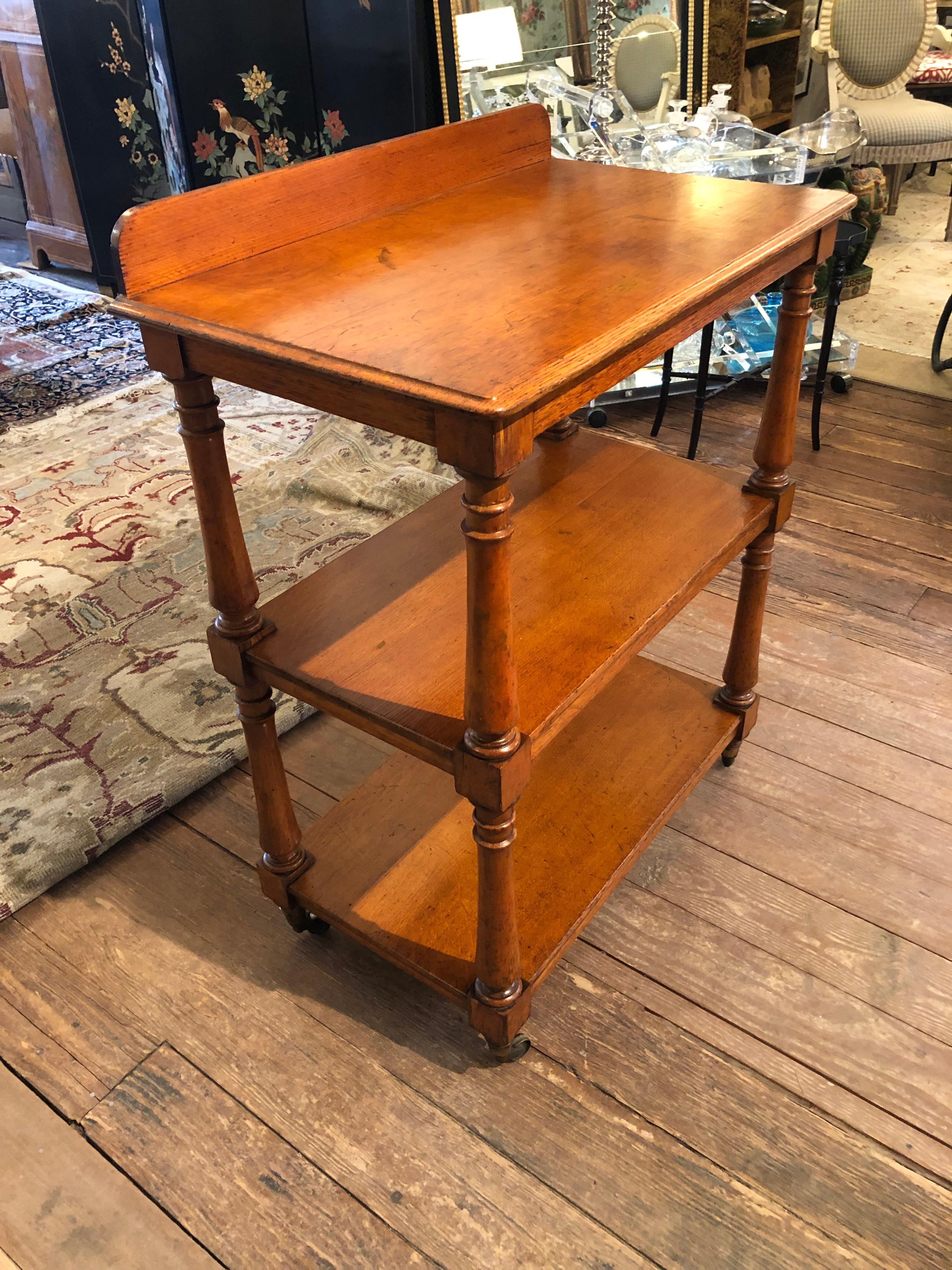 Handsome 3 Tiered Wooden Etagere on Brass Casters In Good Condition For Sale In Hopewell, NJ