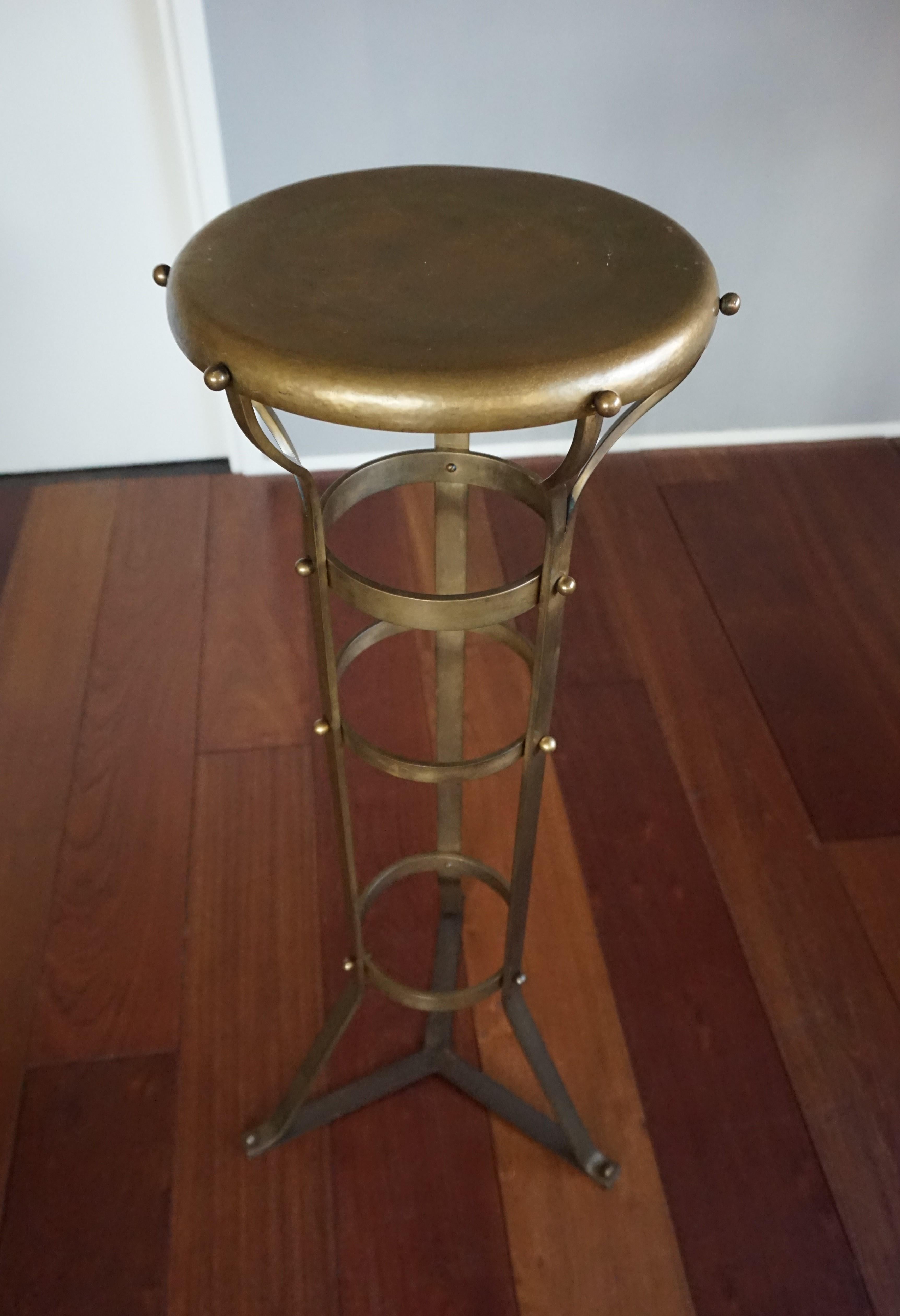 Unique and timeless pedestal stand.

When it comes to Arts & Crafts pedestals this particular piece could very well be the most handsome and stylish we ever had the pleasure of offering. Hand-crafted out of thick, strong and solid brass this weighty