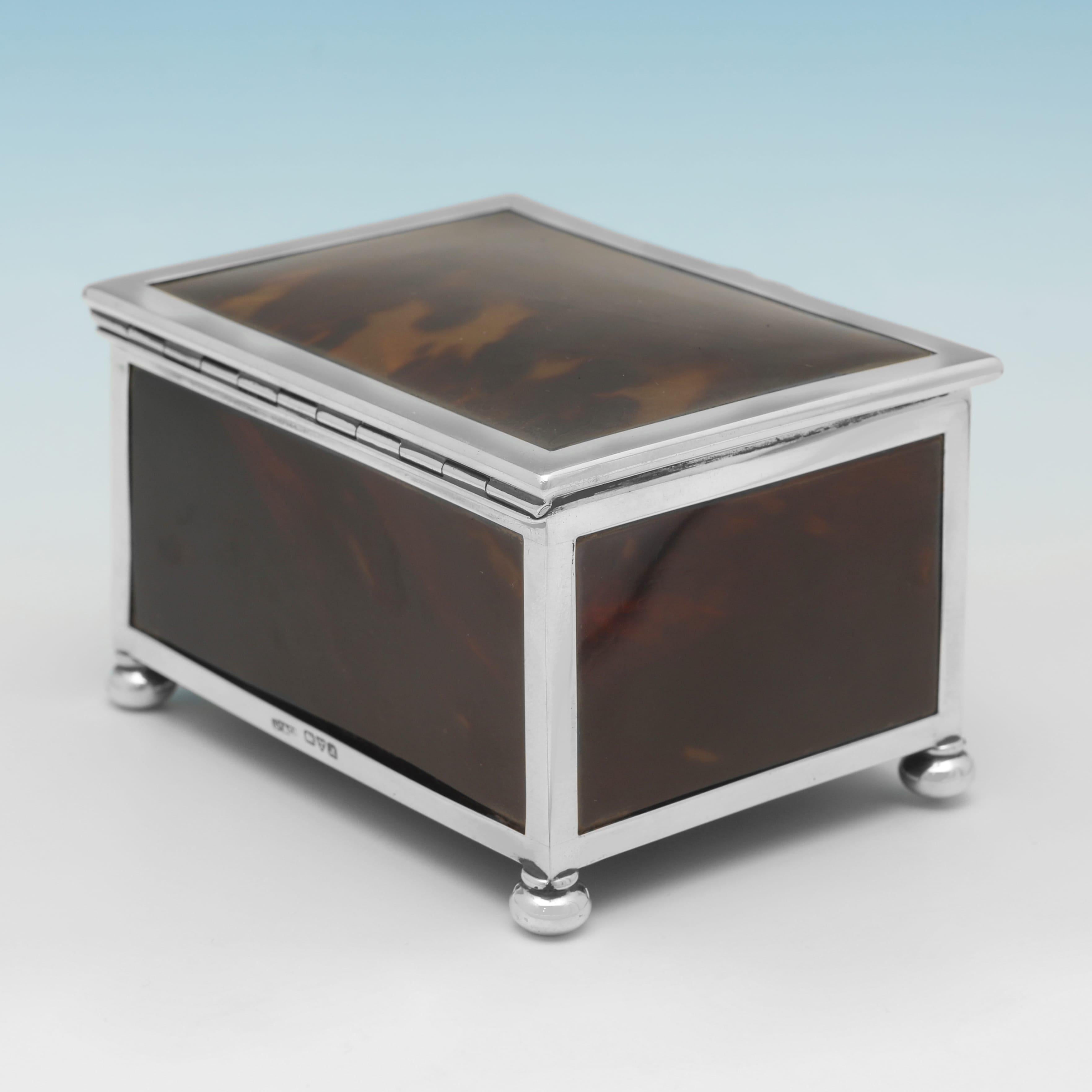 Hallmarked in Chester in 1912 by Grey & Co., this handsome, George V period, Antique Sterling Silver and Tortoiseshell Jewellery Box, is plain in design, standing on four bun feet, and featuring a green fabric lined pad to the inside. The jewellery