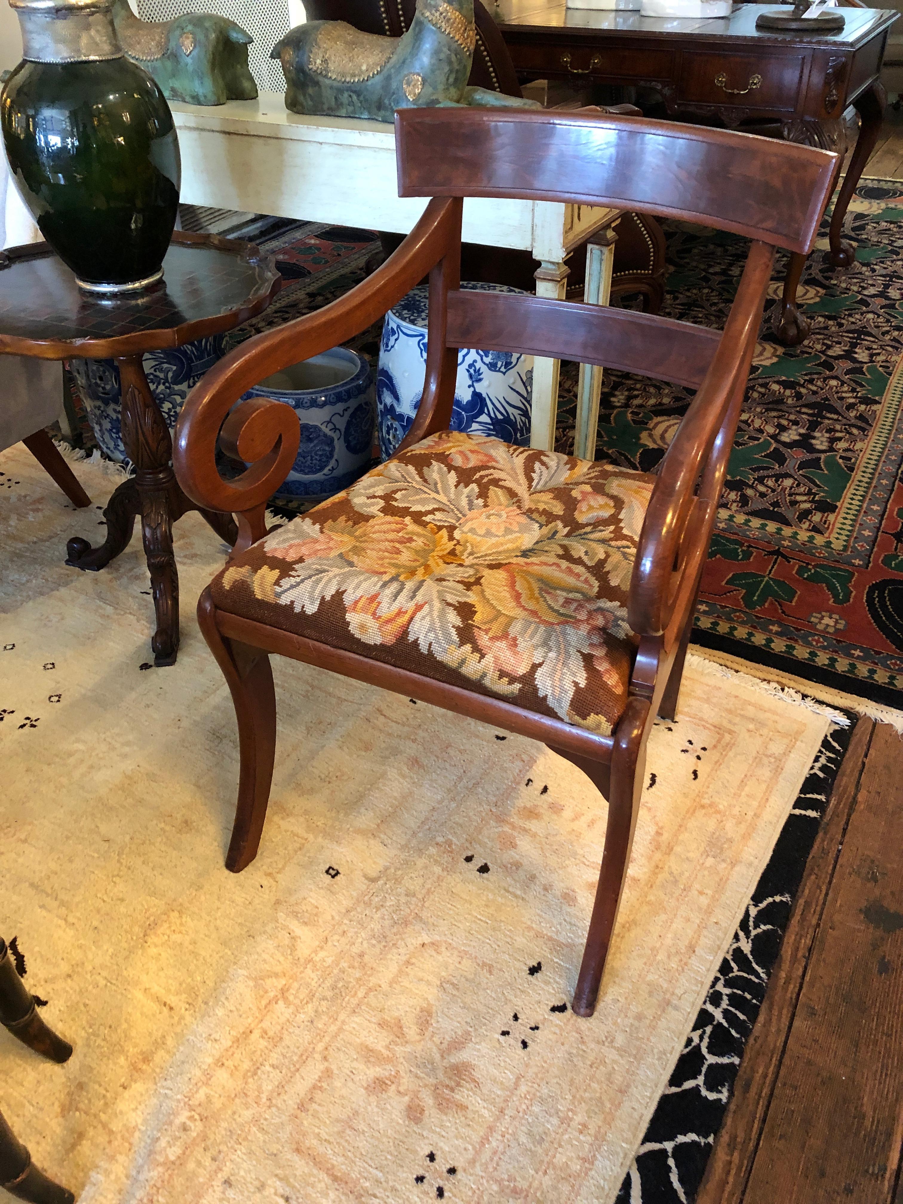 A lovely 19th century mahogany single chair with scroll arms, slat back, and original tapestry seat.
Measures: Seat height 18
Arm height 26.5.
 