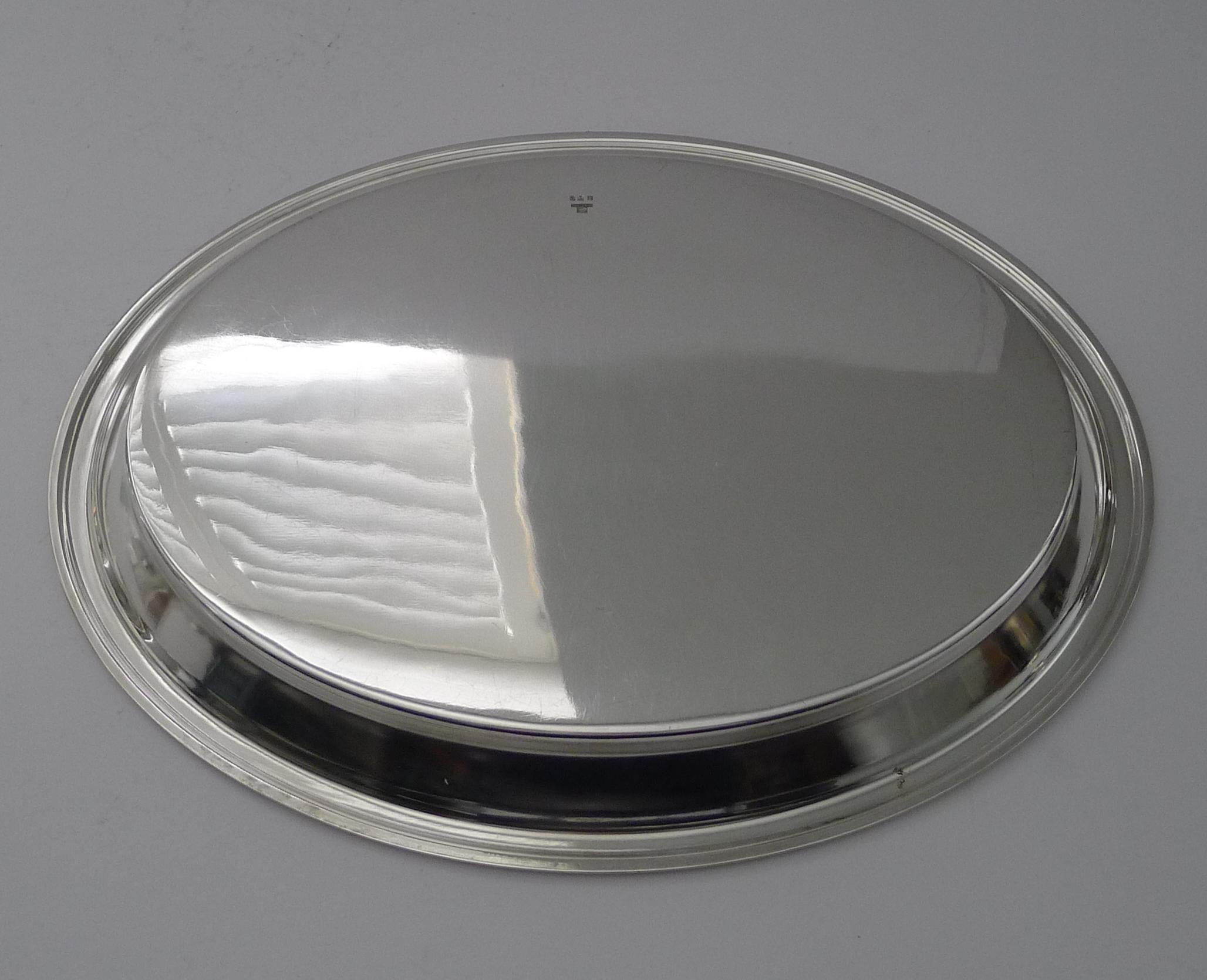 A stylish late Art Deco French cocktail or service tray made from silver plate by the creme de la creme of French silversmith's, Christofle of Paris, fully marked on the underside.

The oval tray has been professionally cleaned and polished in our