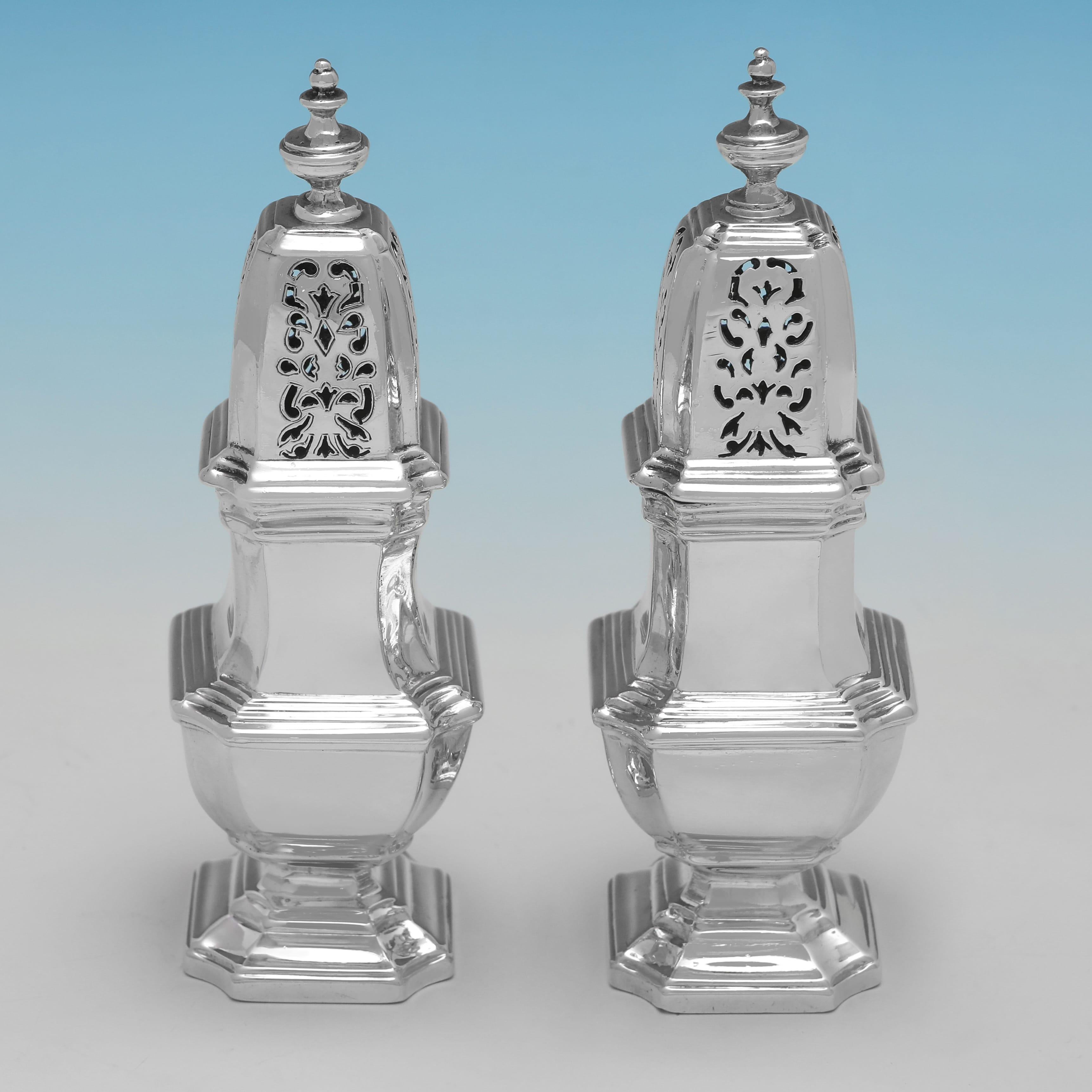 Hallmarked in London in 1929 and 1930 by Richard Comyns, this handsome, Sterling Silver Condiment Set, comprises 2 pepper pots, 2 salt cellars, and a mustard pot, all plain in design and featuring incuse corners and reed detailing. The set together