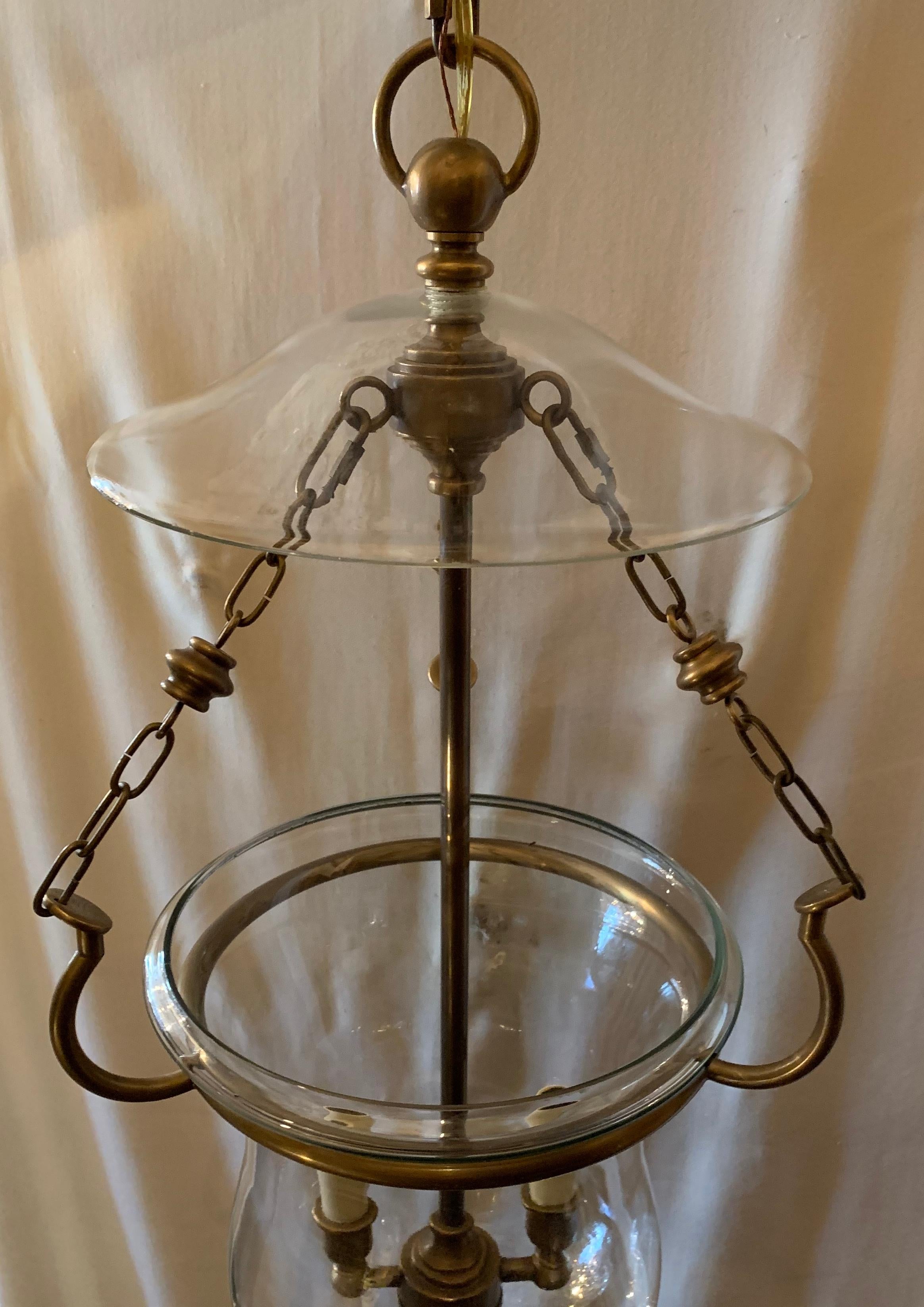 A handsome and fine quality blown glass and bronze bell jar lantern with 2 candelabra lights, this fixture we are told is vintage Vaughan, made in England.
Wire has been updated and comes with chain and canopy as well as mounting hardware for