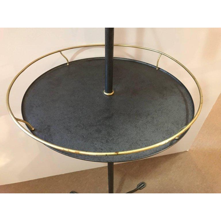Elegant brass and galvanized metal standing shaving or dressing mirror with shield shaped mirror flanked by two arm candleholders and having a gallery edge table resting on a tripod base.