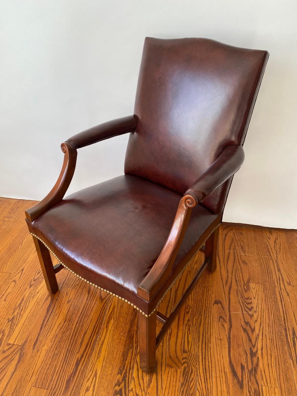 This new handsome Chippendale style mahogany gainsborough chair sits comfortably in the office, den, library or living room. The serpentine shaped top and seat front, along with, the uncommon chamfered stretcher add to its distinction. This