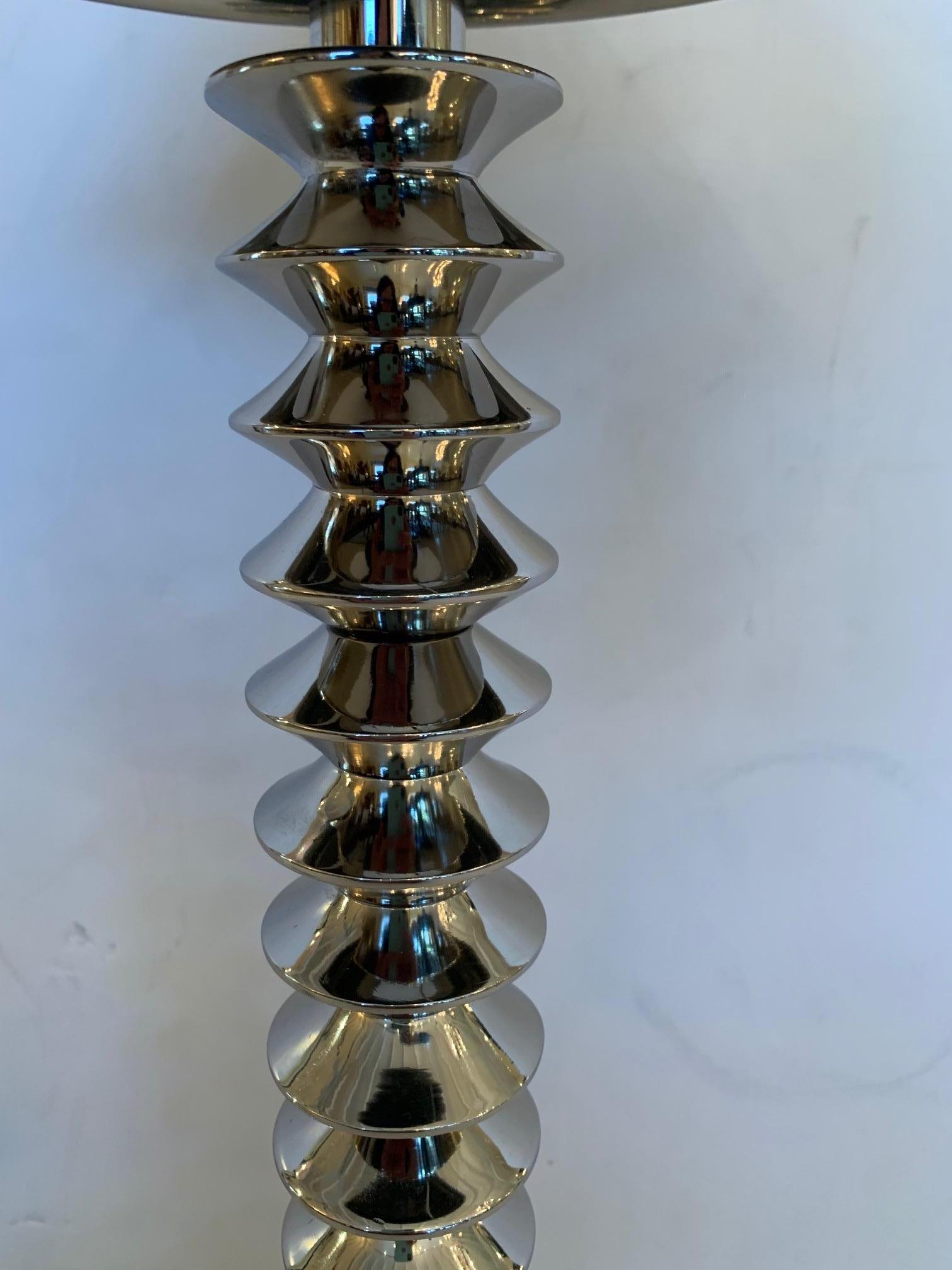 Shiny and stylish chrome table lamp having spiral candlestick column and glamorous silver metal shade.
Note: Pair available.