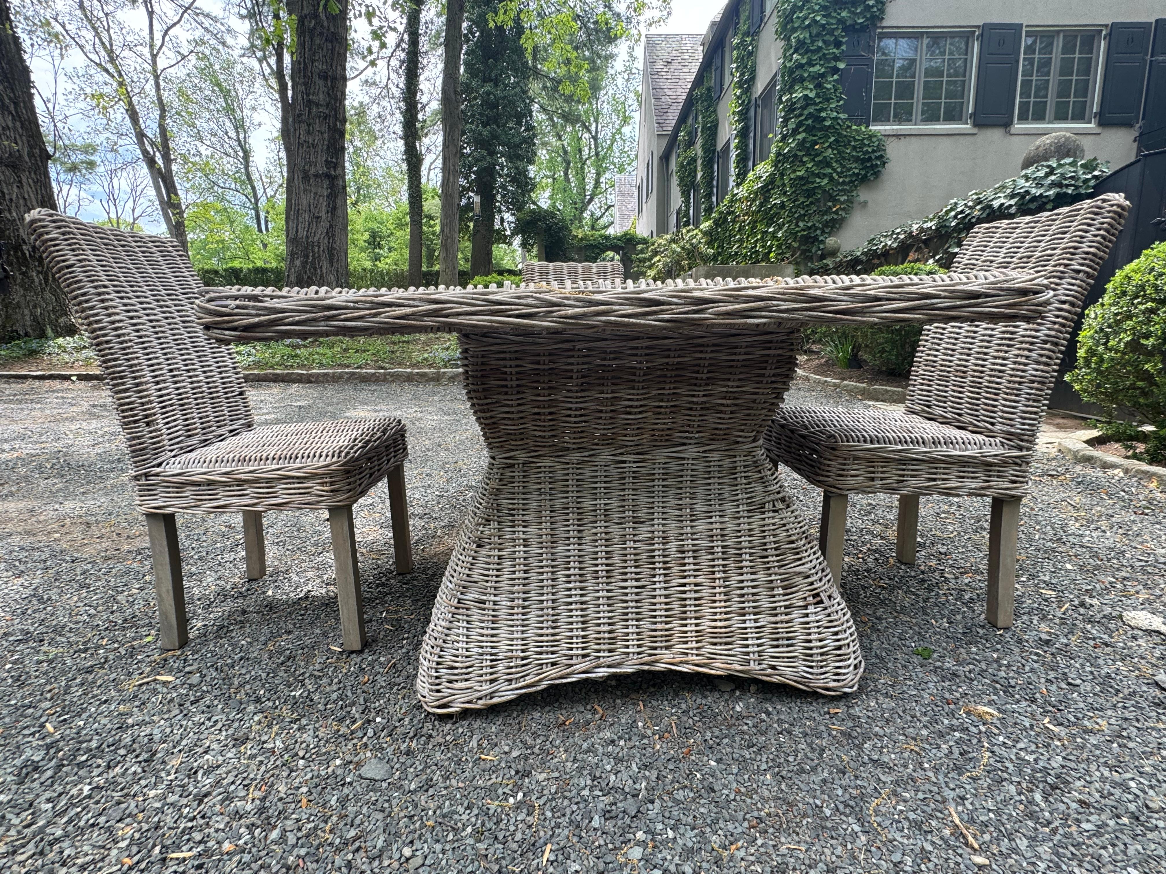 Stylish square dining table and 4 straight back chairs in handsome woven rattan.  Can be used on covered porch but not exposed to direct weather.
31” knee clearance