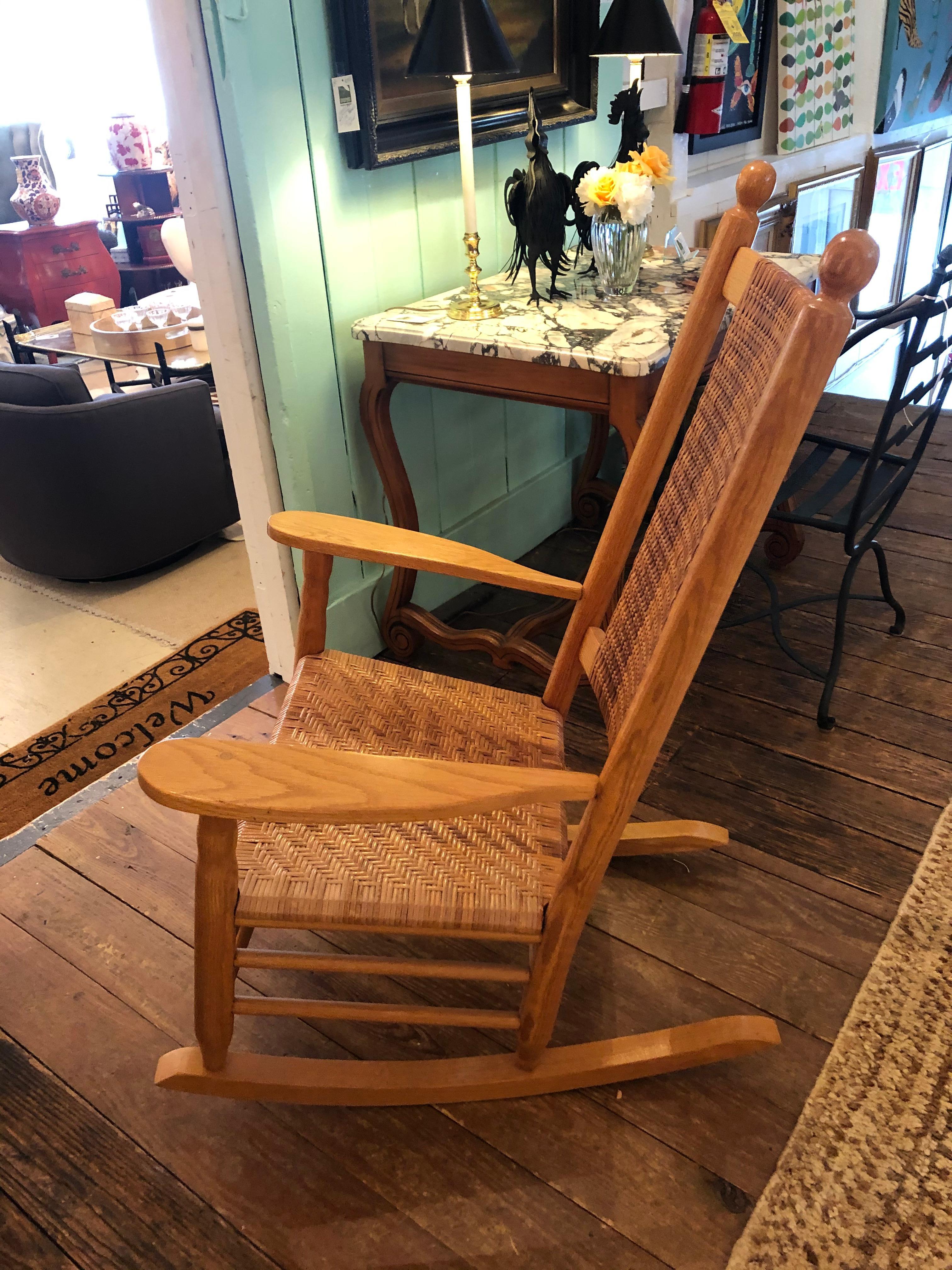 A handsome sturdy Shaker style light oak rocking chair having caned seat and double caned back. Very comfortable.