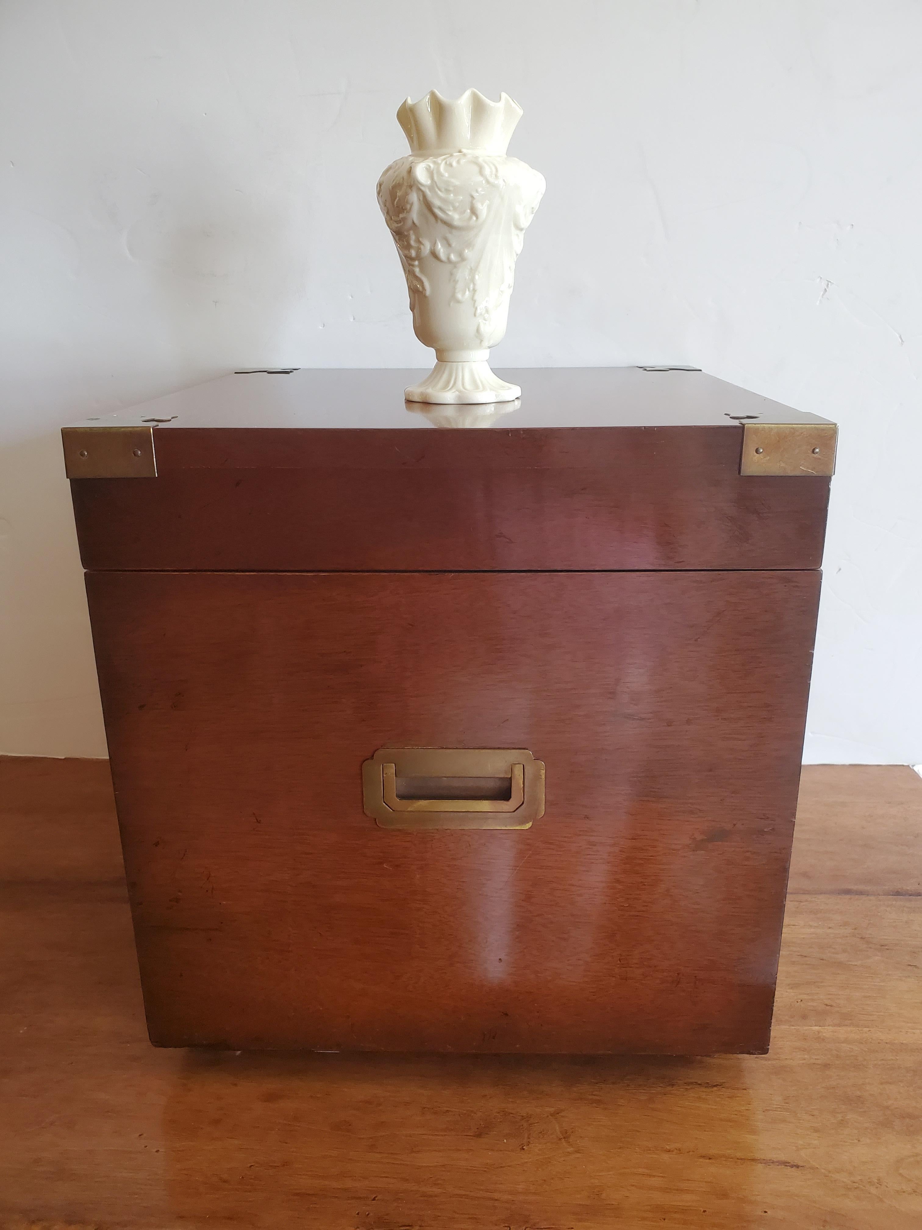 Very handsome multi functional square cube mahogany trunk having gorgeous brass decorative corners on top and side recesssed brass handles. The top lifts up to reveal storage inside. A great size for use as a side or end table.