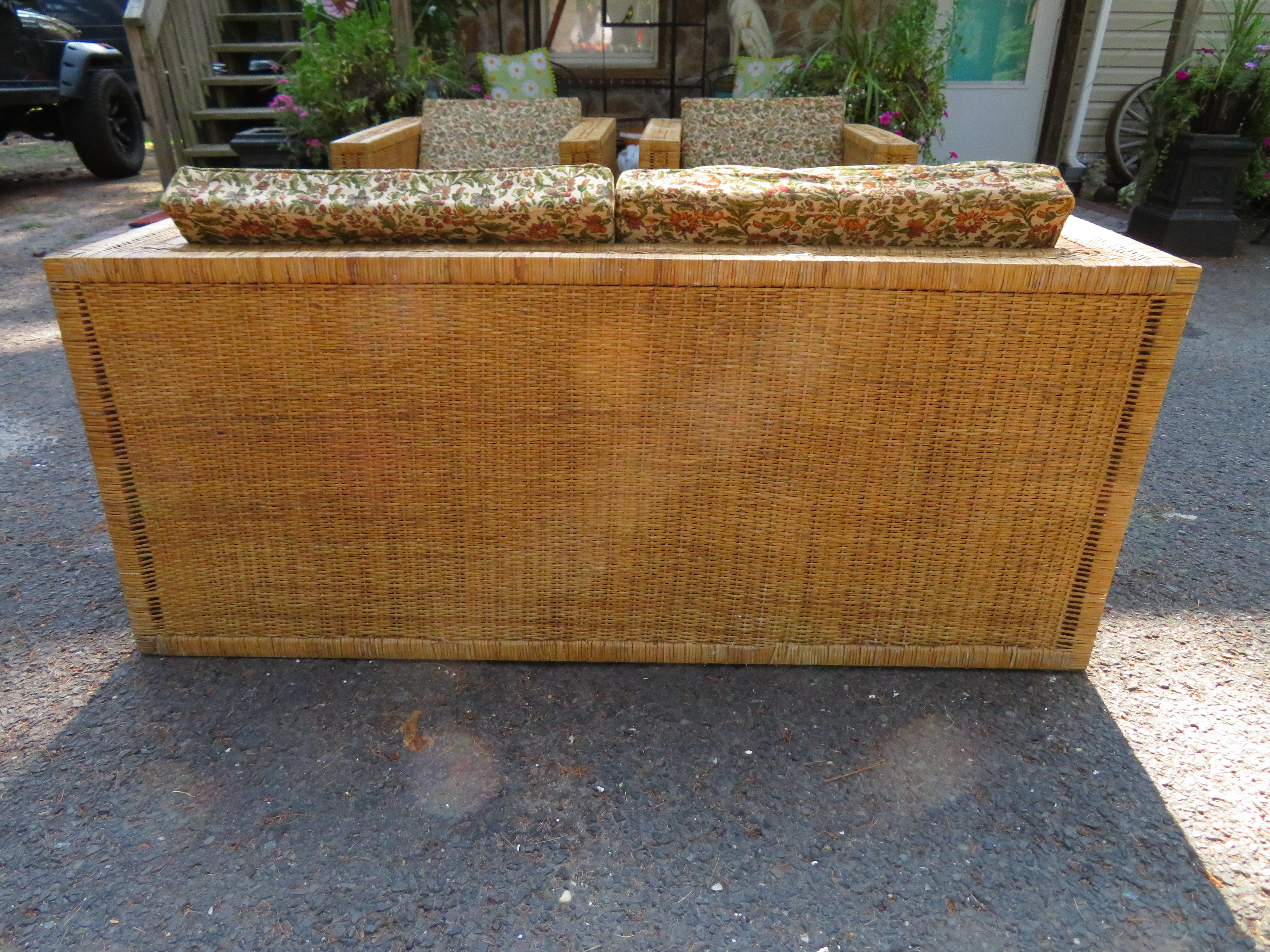 Handsome Danny Ho Fong style wicker cube Parson loveseat. This loveseat will need new cushions which we can certainly help with. The wicker is in great shape and has only light signs of age. We do have other pieces from this collection-as shown in