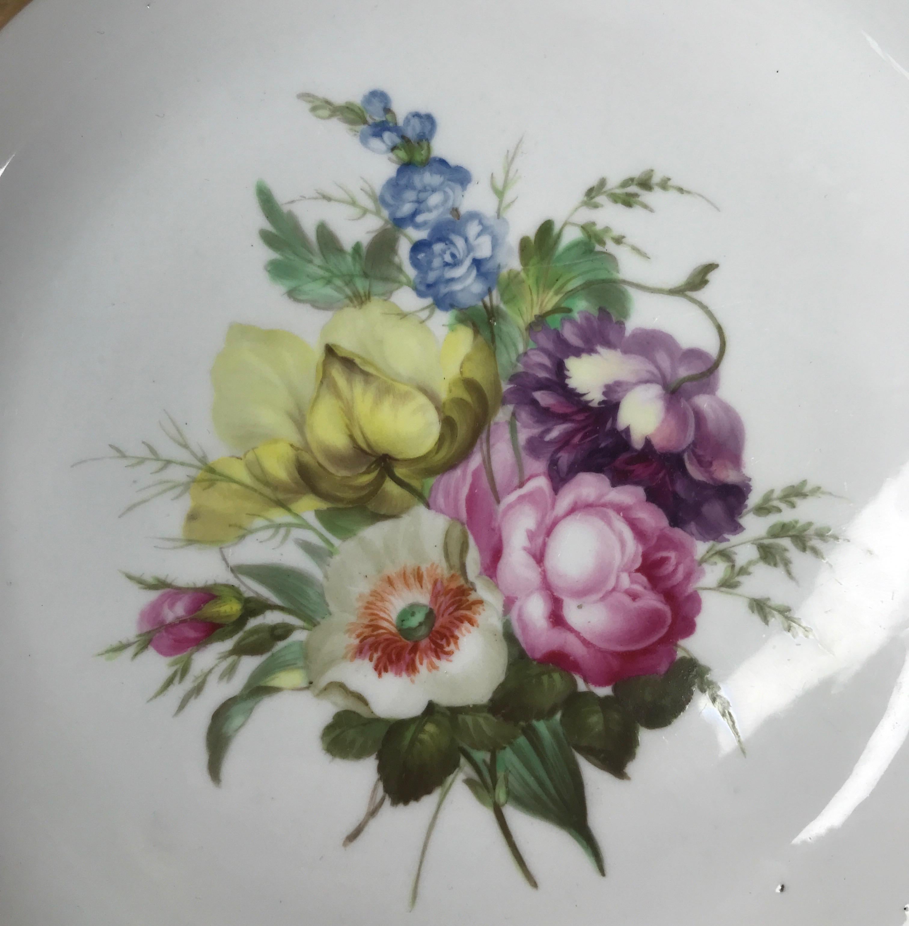 Derby plate with spiral fluted rim, superbly painted with a central large group of flowers, including pink rose and various poppies, in the manner of William Billingsley, the rim with a wide foliate gilt border.
Puce Crown & Batons mark above