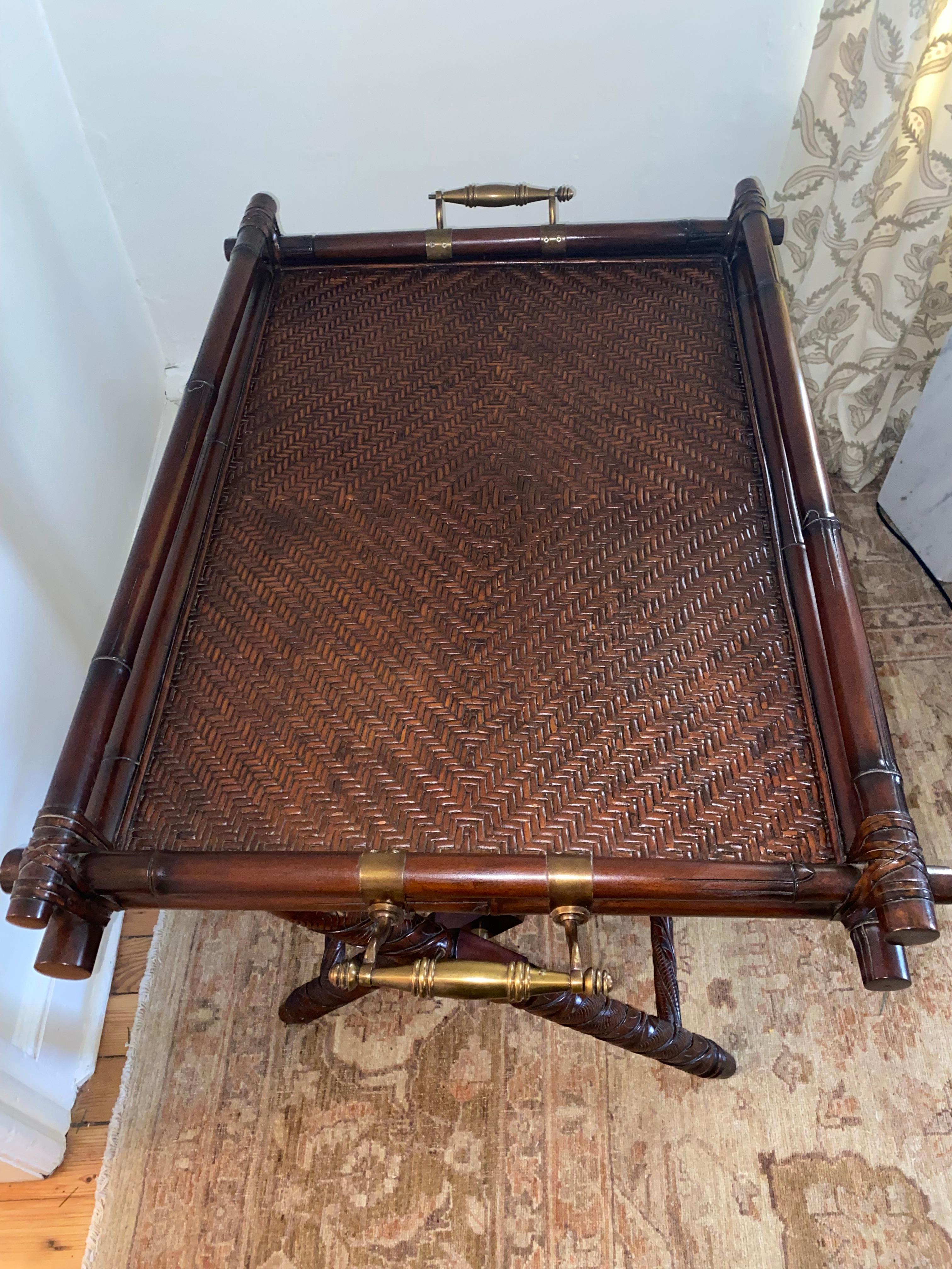 Sumptuously crafted by Ralph Lauren, the Sussex Butler’s tray on stand having mahogany and rattan with brass handles.
Label plaque on underside.