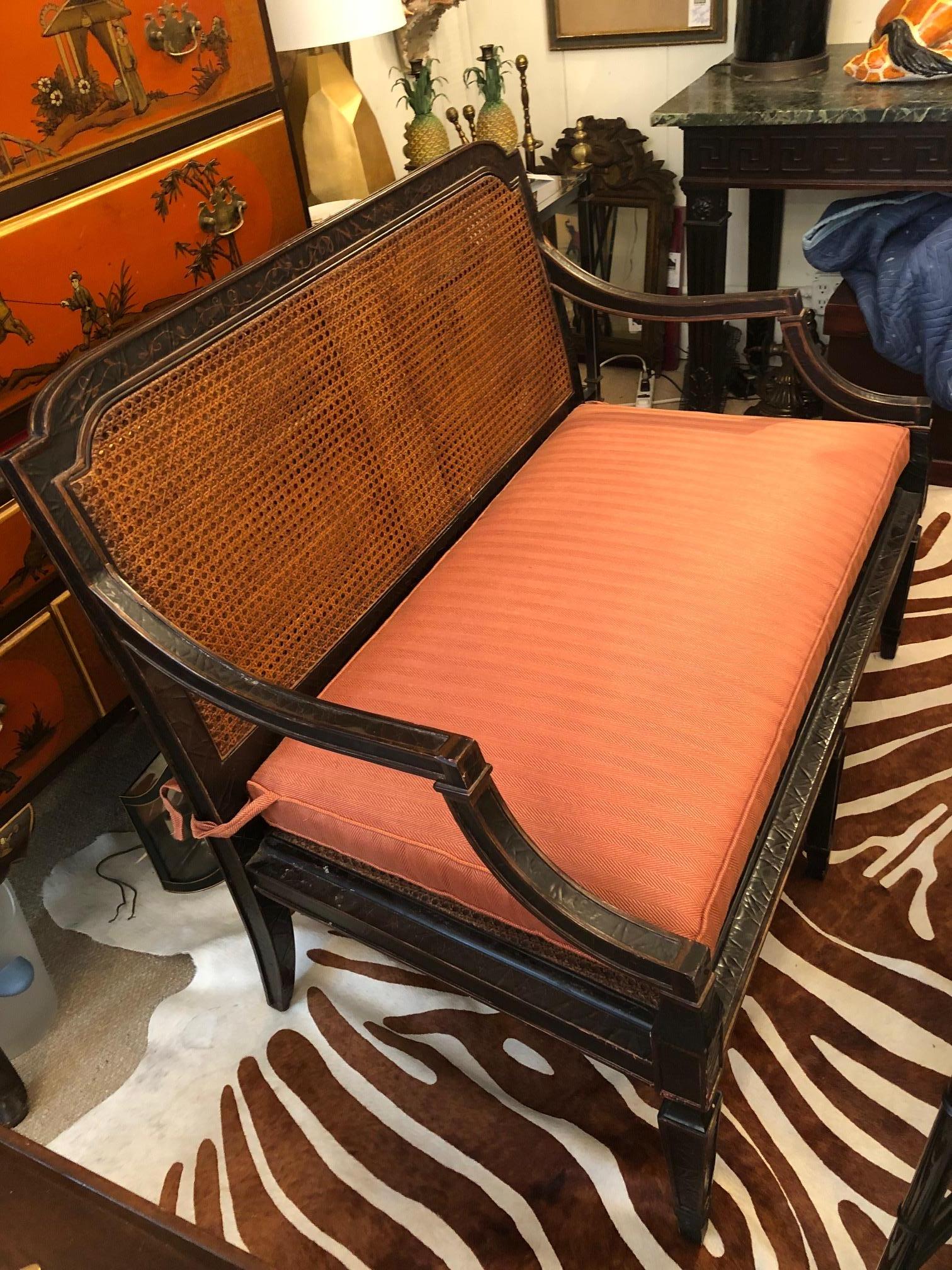 Handsome chinoiserie style hand painted black and muted warm bronzey gold loveseat having stunning caned seat and double caned back. A separate custom cushion is included.
arm height 25.75
seat height without cushion 14.25
top width of loveseat