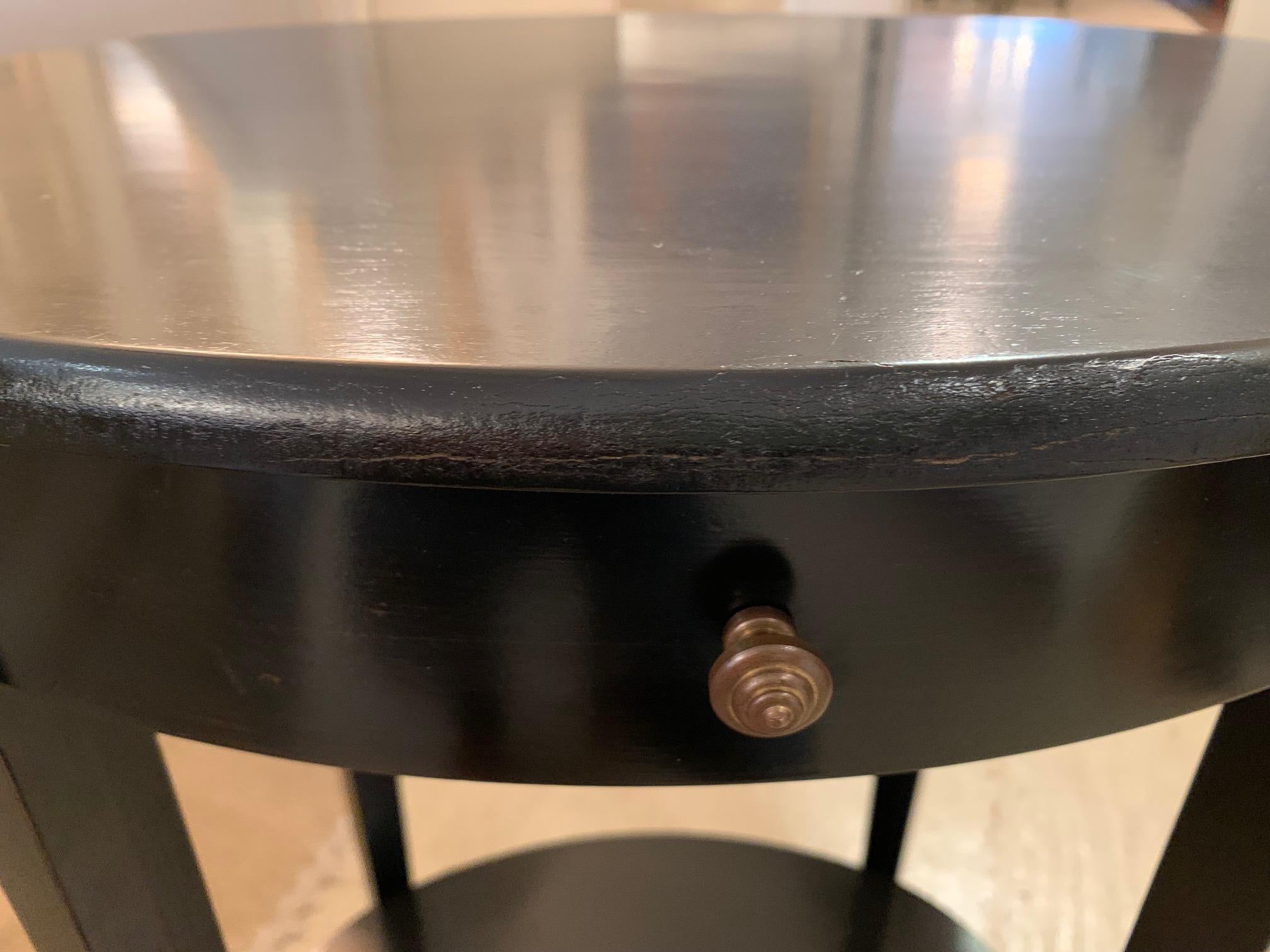 Handsome ebonized espresso finish oval side or end table having single drawer and second lower tier.