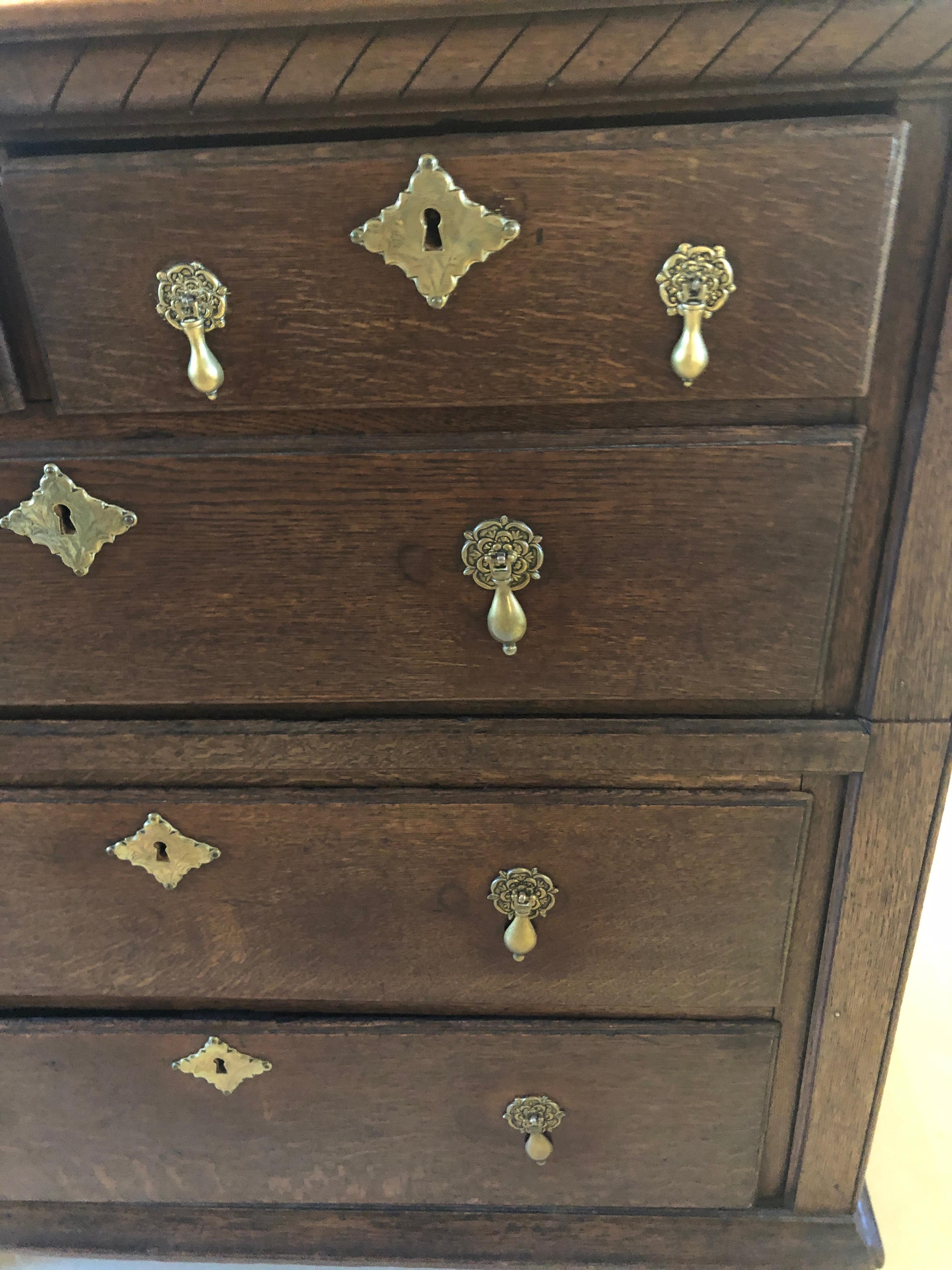 Stunning masculine English walnut chest of drawers having two small drawers at the top and 3 large drawers underneath. Original brass hardware is beautiful and all drawers work smoothly.