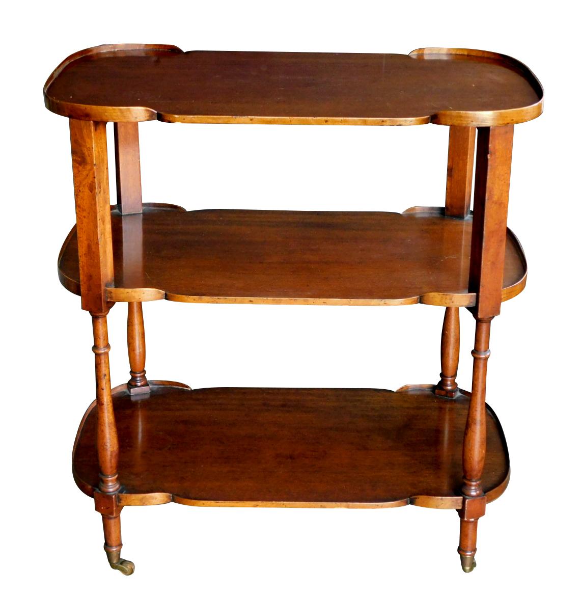perfect for a bar cart or an étagère, fitted with three shaped shelves each with perimeter gallery; all raised on turned supports ending in casters