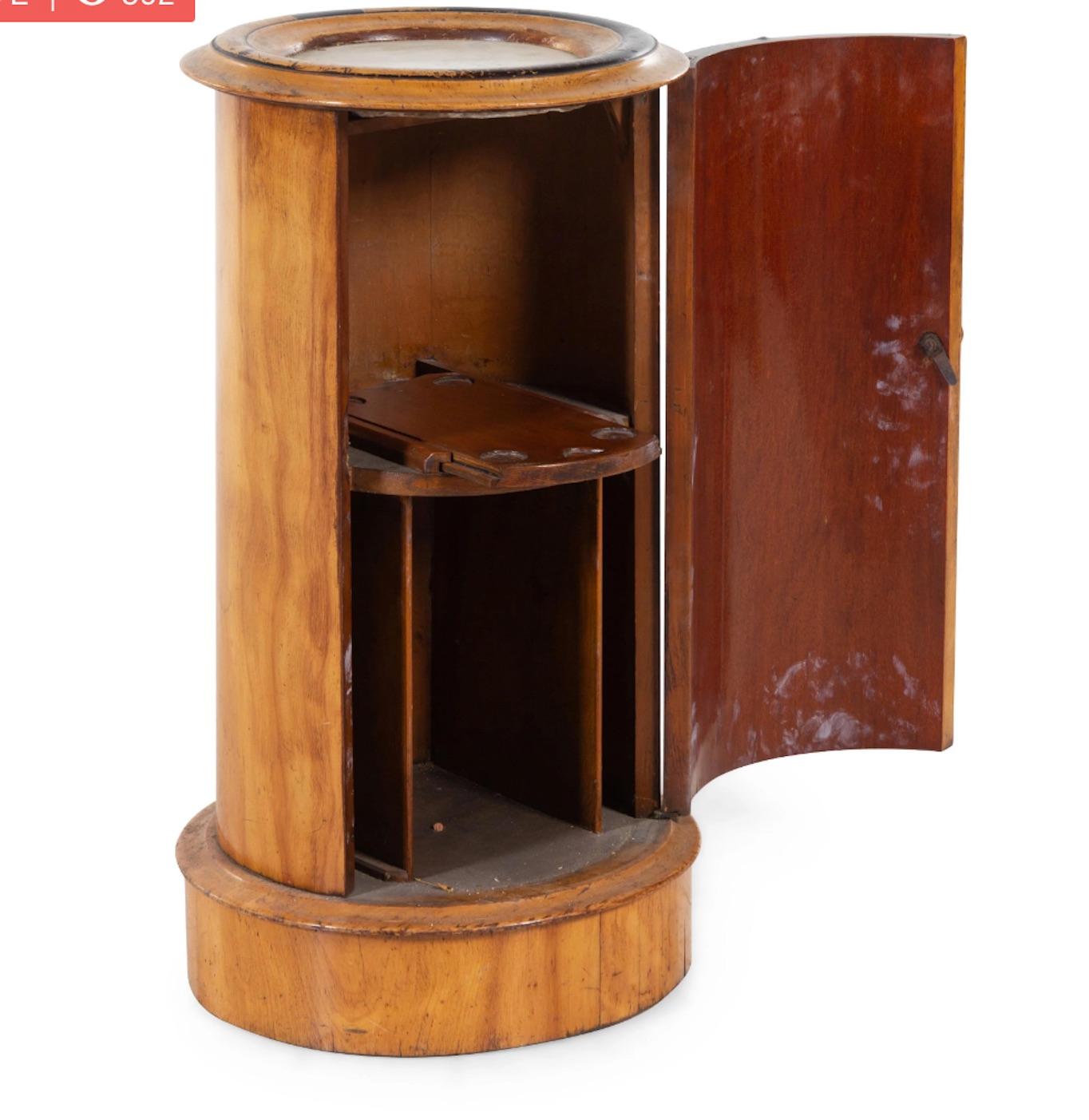 Handsome associated pair English mahogany cylindrical side table with one white marble top, one black marble top. Great color and proportion for a tight space with storage underneath.