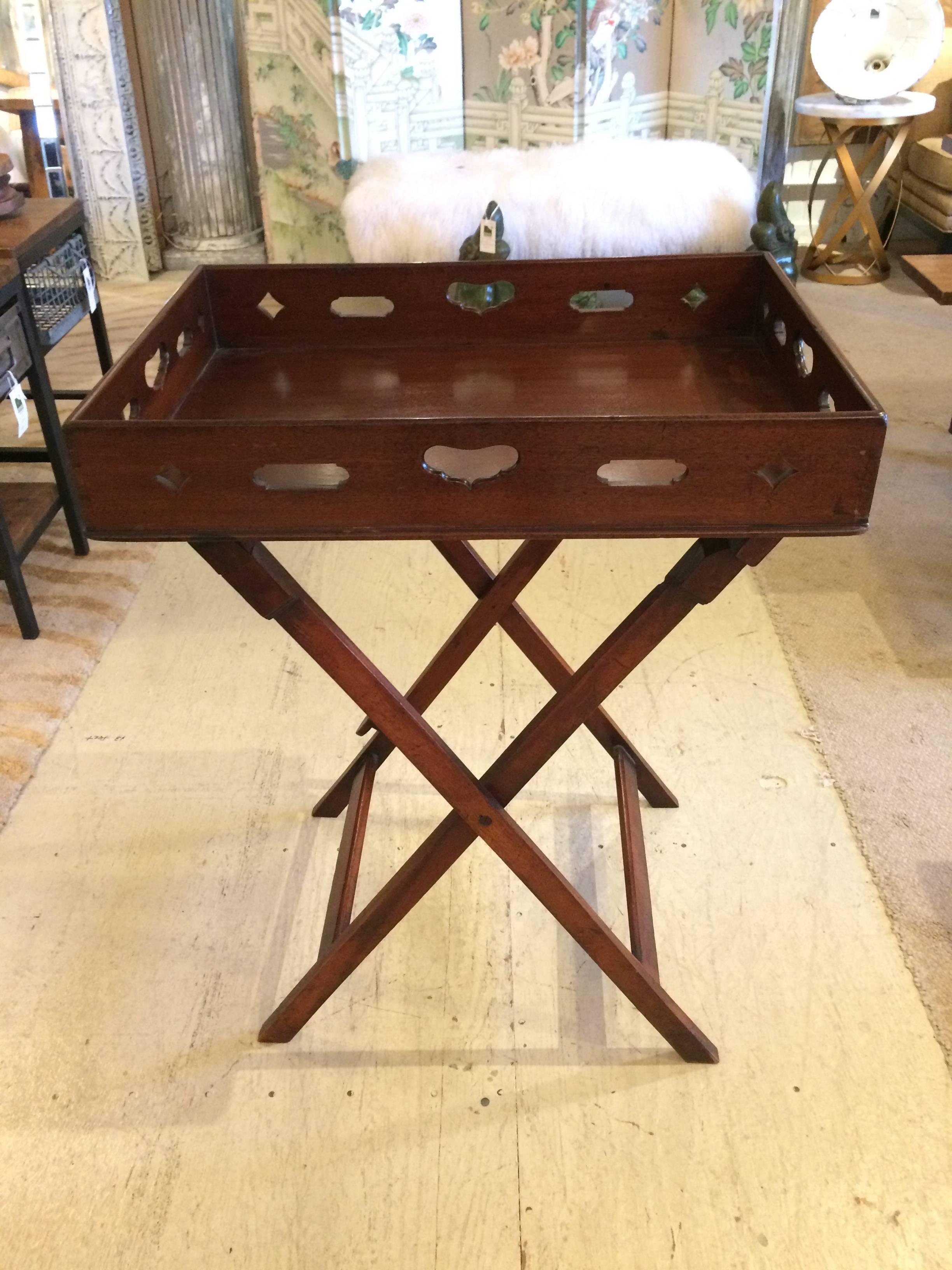 Great looking and versatile mahogany tray table having a removable tray top with cut-out handles, and a folding wooden stand.