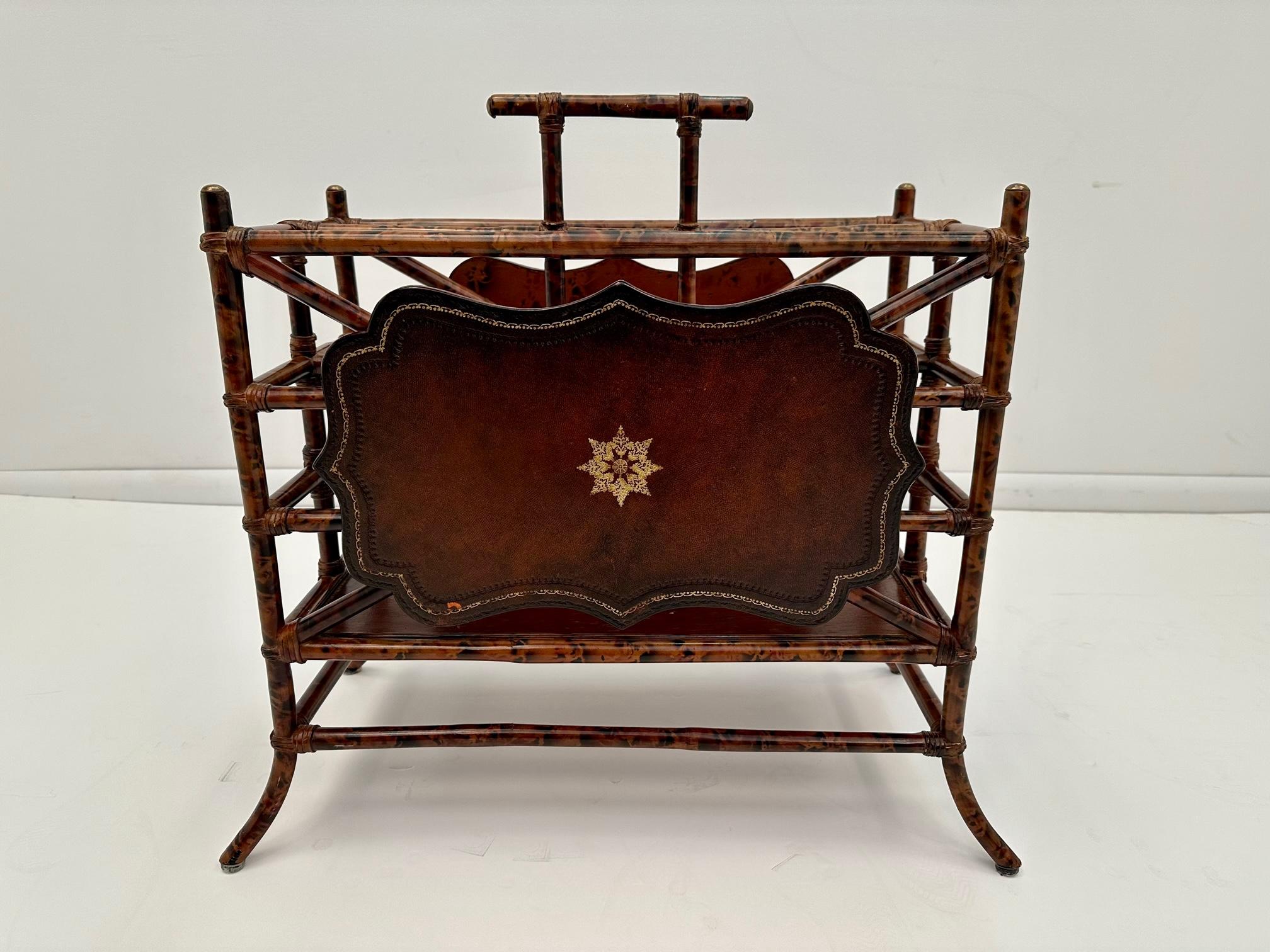Stunning beautifully made magazine rack by Maitland Smith having its signature tooled leather with gold medallion embellishment, brass details and faux bamboo structure.