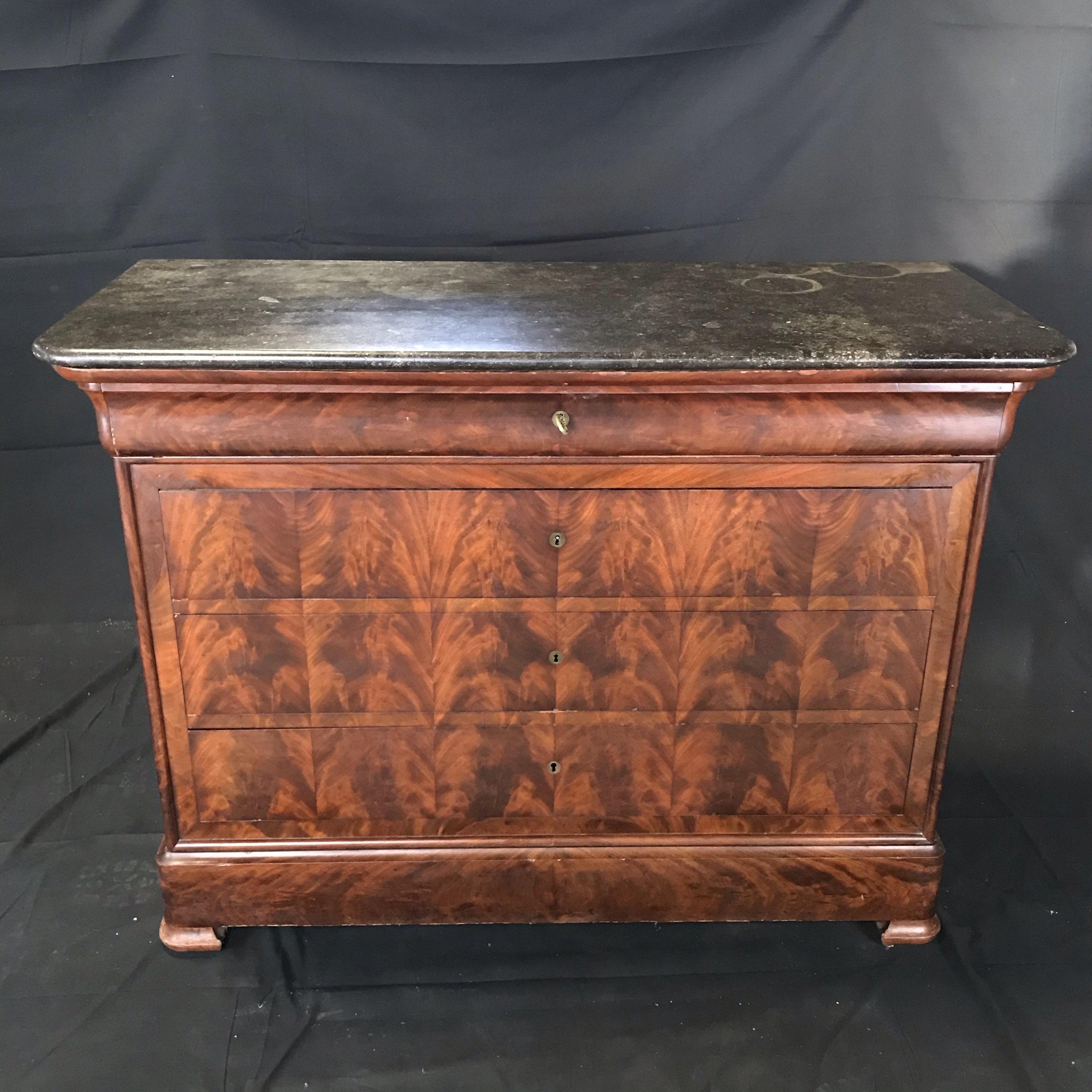 Gorgeous French Empire period commode having five drawers - top drawer with compartments, 3 large drawers for storage, and bottom secret drawer! Key opens drawers.
Top is black and grey marble.
#3483.